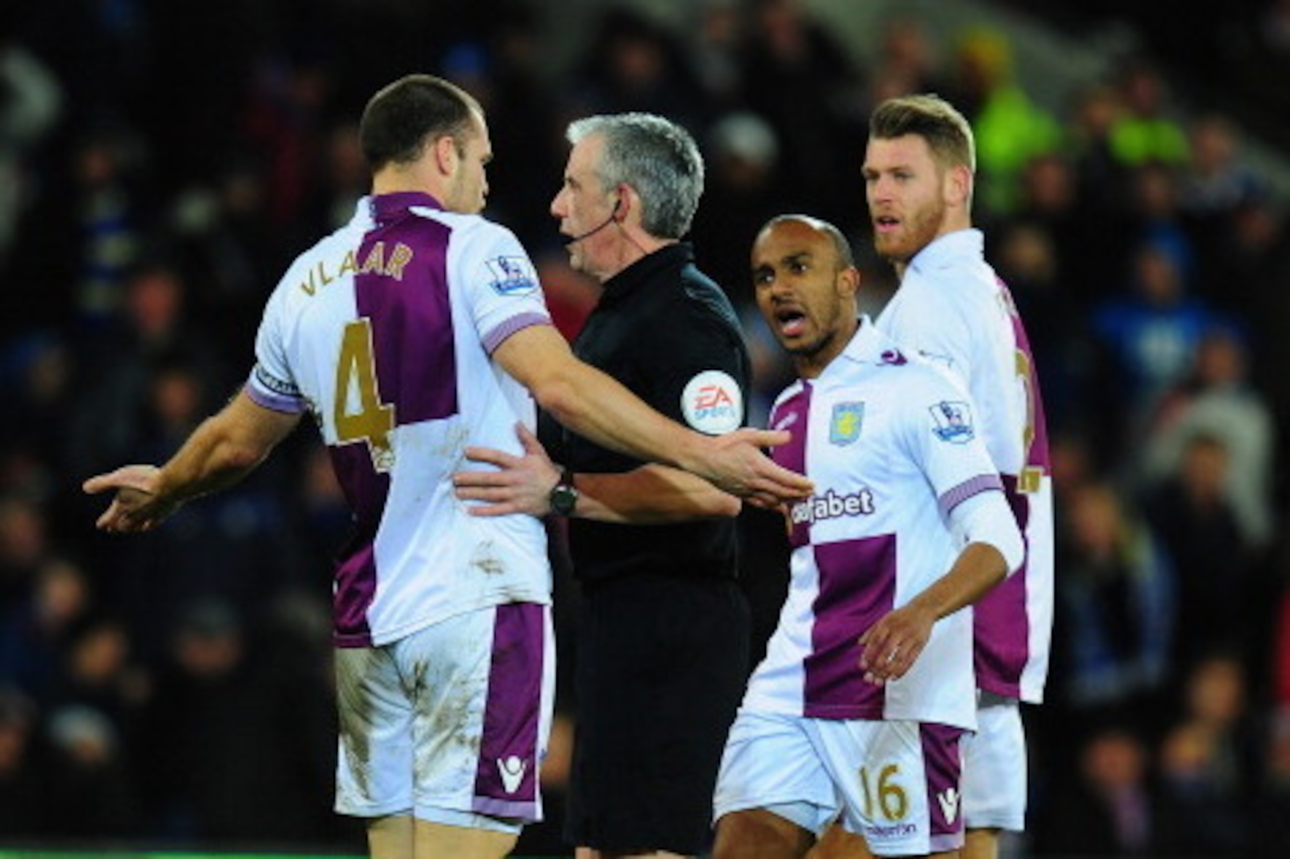 CARDIFF, WALES - FEBRUARY 11:  Ron Vlaar of Villa and Fabian Delph (c) have words with referee Chris Foy  during the Barclays Premier League match between Cardiff City and Aston Villa at Cardiff City Stadium on February 11, 2014 in Cardiff, Wales.  (Photo