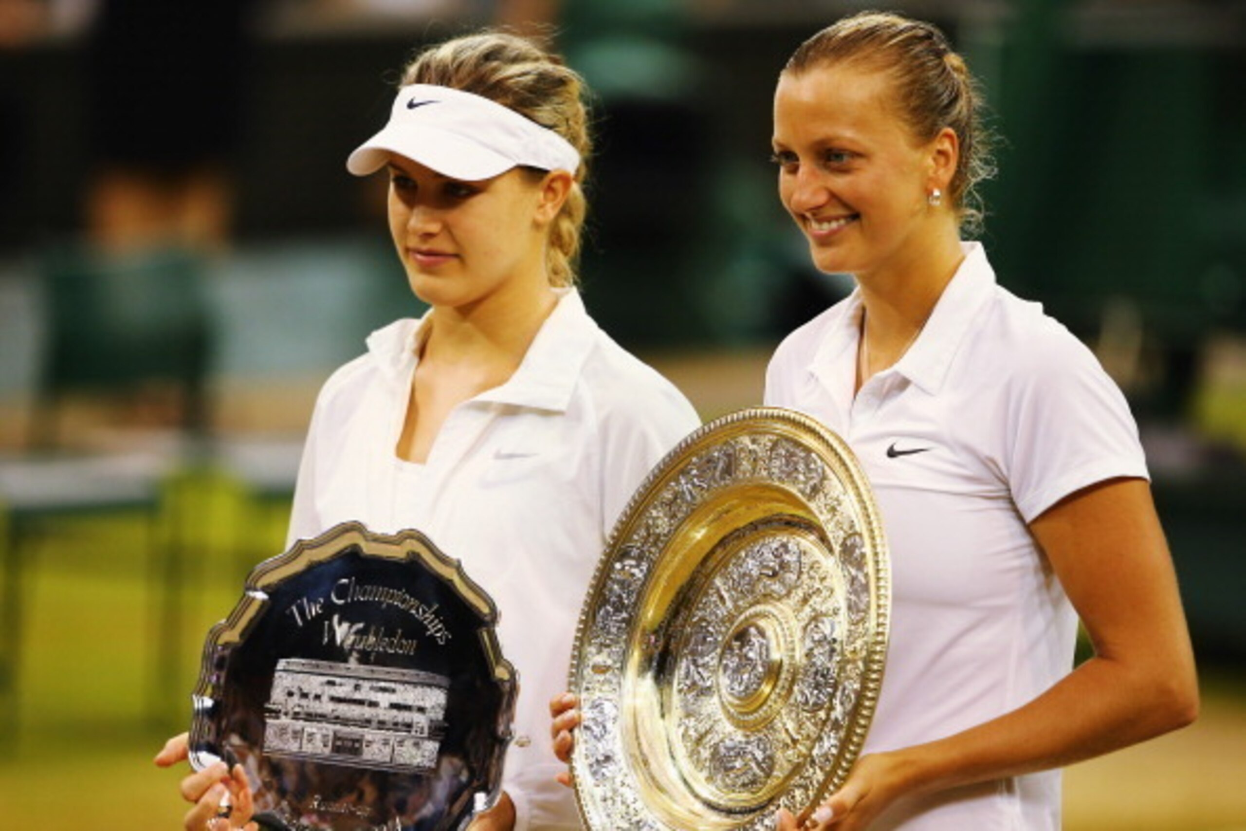 LONDON, ENGLAND - JULY 05:  Petra Kvitova of Czech Republic poses with the Venus Rosewater Dish trophy next to Eugenie Bouchard of Canada and her runner-up trophy after their Ladies' Singles final match on day twelve of the Wimbledon Lawn Tennis Champions