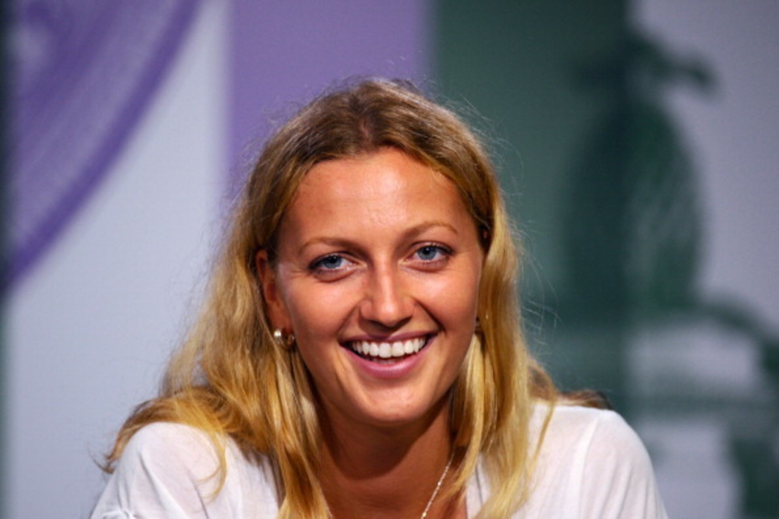 LONDON, ENGLAND - JULY 05:  Petra Kvitova of Czech Republic smiles as she speaks to members of the media at a press conference following her victory in the Ladies' Singles final match against Eugenie Bouchard of Canada on day twelve of the Wimbledon Lawn 