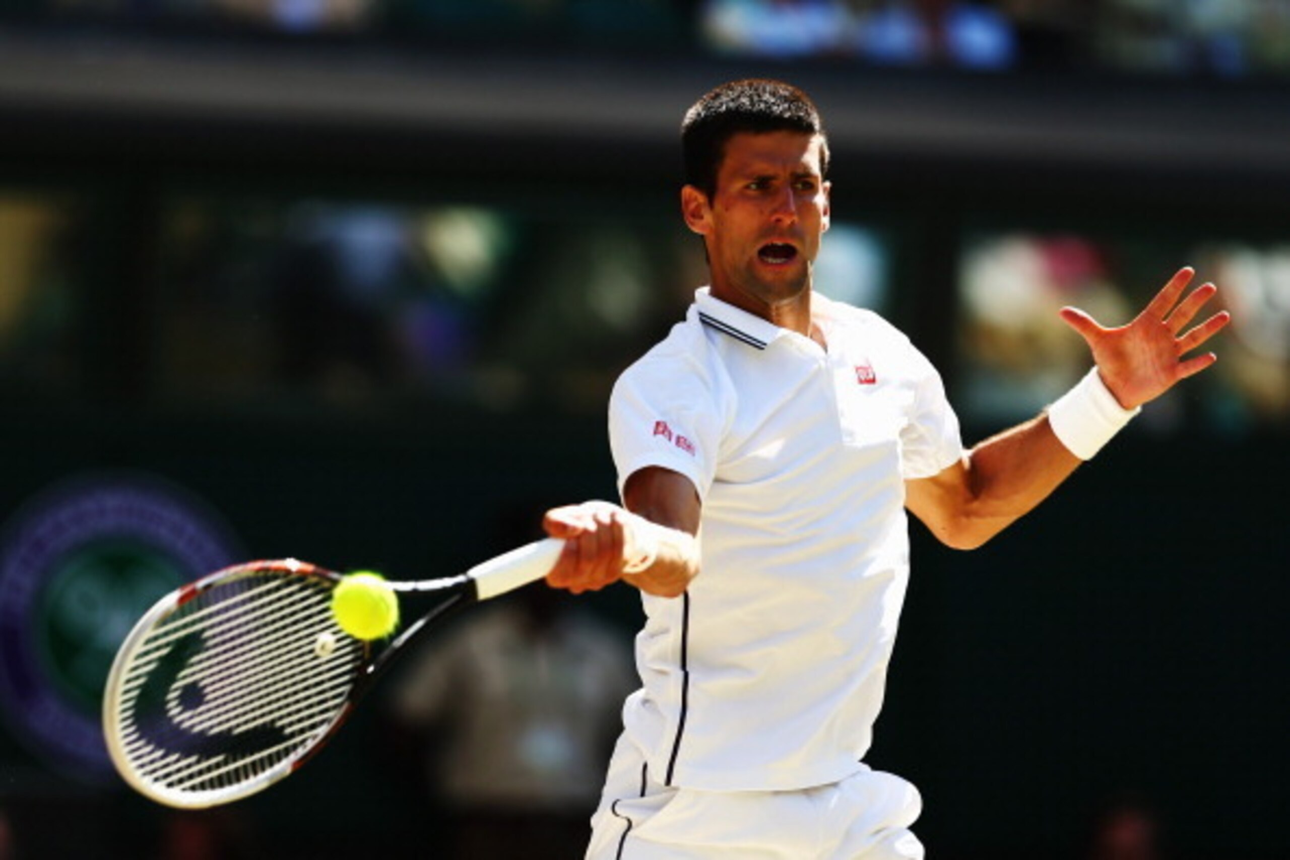 LONDON, ENGLAND - JULY 04:  Novak Djokovic of Serbia plays a forehand return during his Gentlemen's Singles semi-final match against Grigor Dimitrov of Bulgaria on day eleven of the Wimbledon Lawn Tennis Championships at the All England Lawn Tennis and Cr