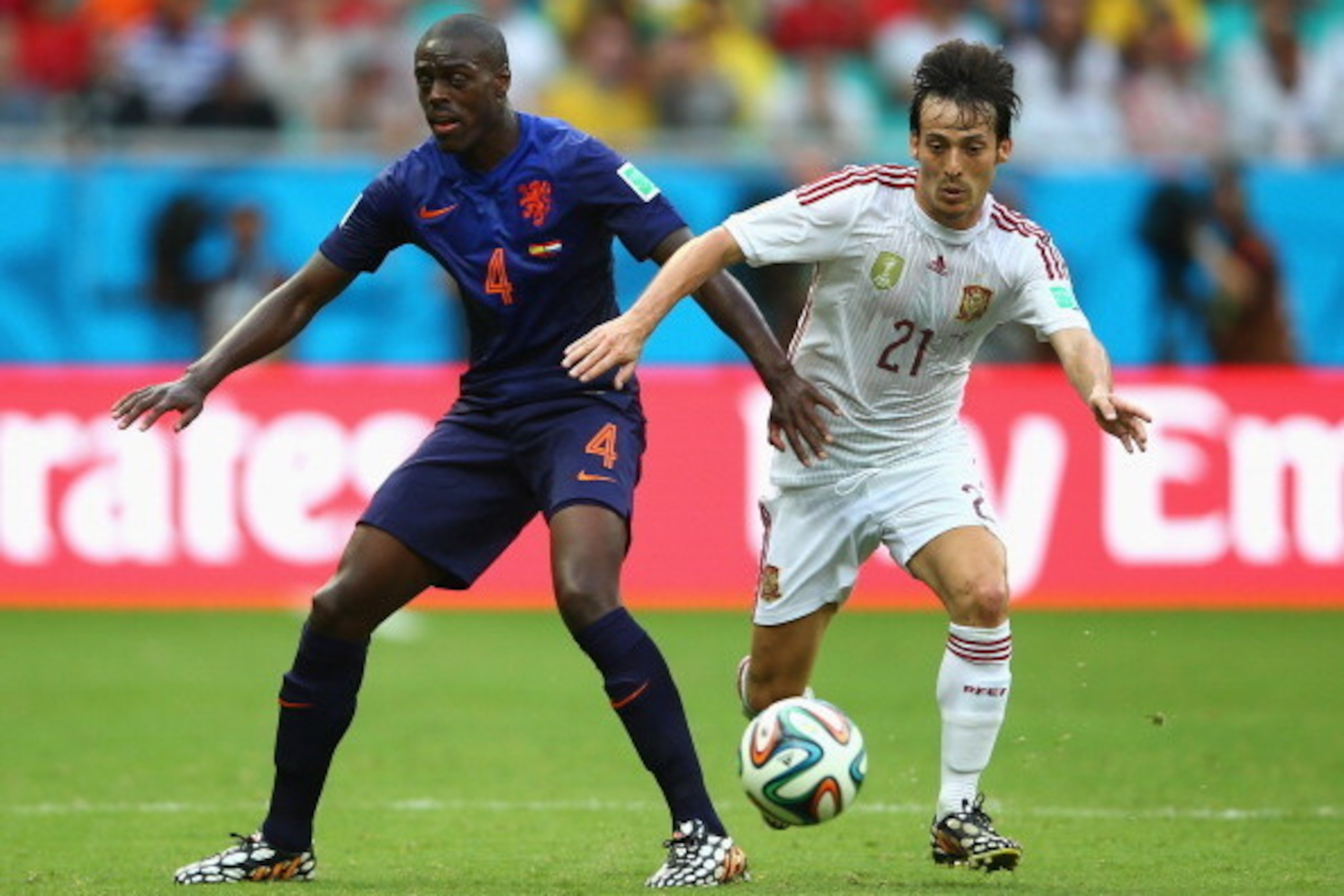 SALVADOR, BRAZIL - JUNE 13:  David Silva of Spain beats Bruno Martins Indi of the Netherlands during the 2014 FIFA World Cup Brazil Group B match between Spain and Netherlands at Arena Fonte Nova on June 13, 2014 in Salvador, Brazil.  (Photo by Paul Gilha