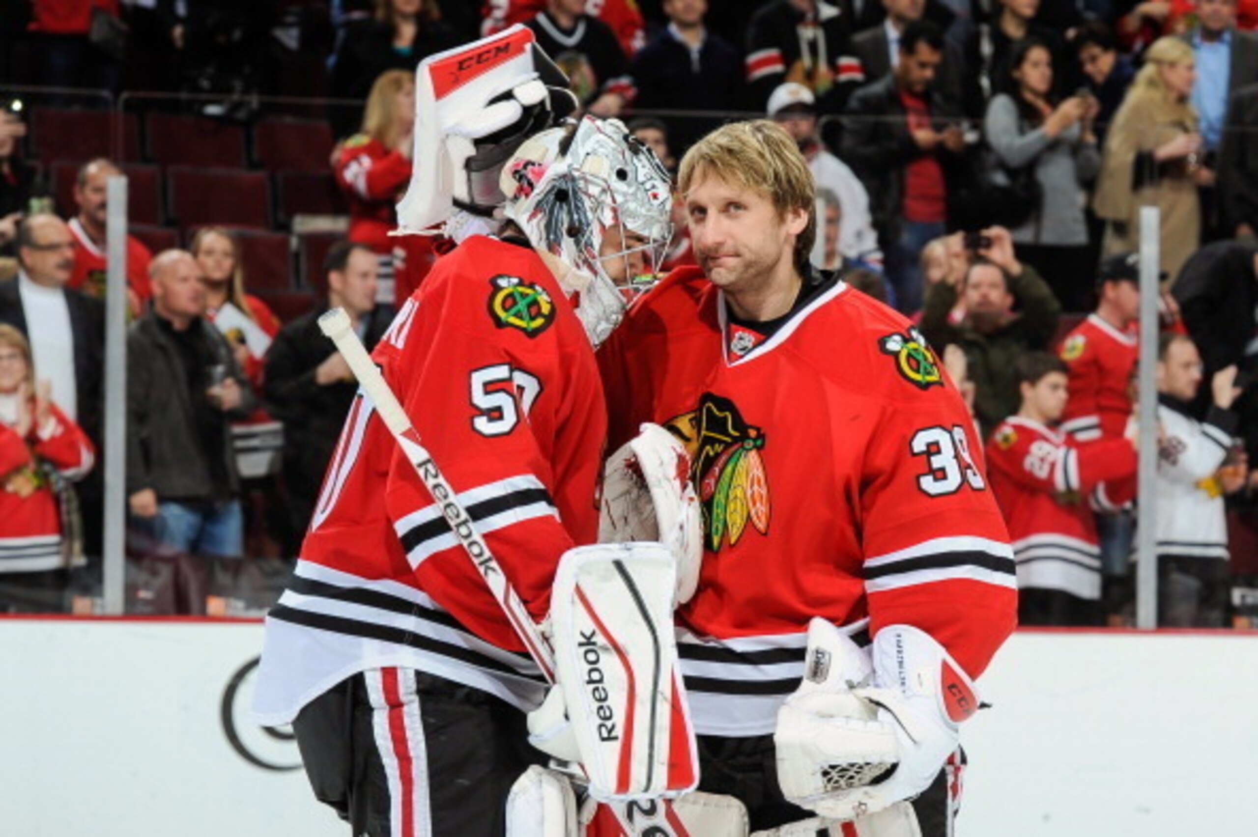 CHICAGO, IL - NOVEMBER 6: Goalies Corey Crawford #50 and Nikolai Khabibulin #39 of the Chicago Blackhawks celebrate after defeating the Winnipeg Jets during the NHL game on November 06, 2013 at the United Center in Chicago, Illinois. (Photo by Bill Smith/