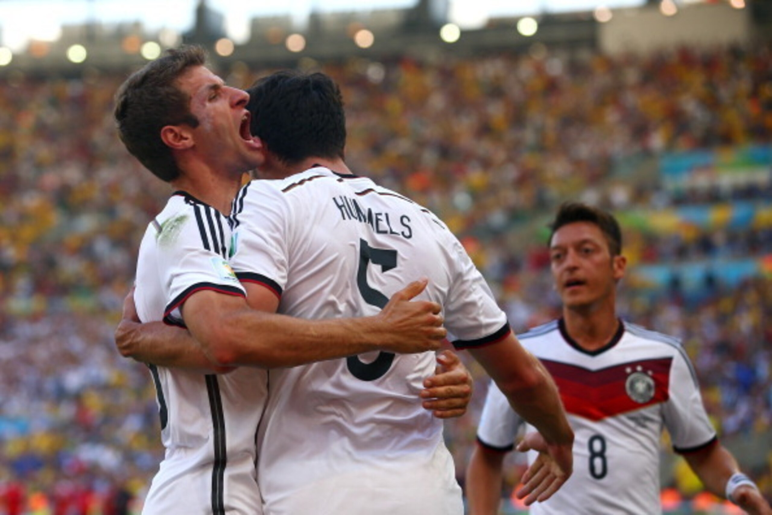 RIO DE JANEIRO, BRAZIL - JULY 04:  Mats Hummels of Germany (C) celebrates scoring his team's first goal with Thomas Mueller (L) and Mesut Oezil during the 2014 FIFA World Cup Brazil Quarter Final match between France and Germany at Maracana on July 4, 201