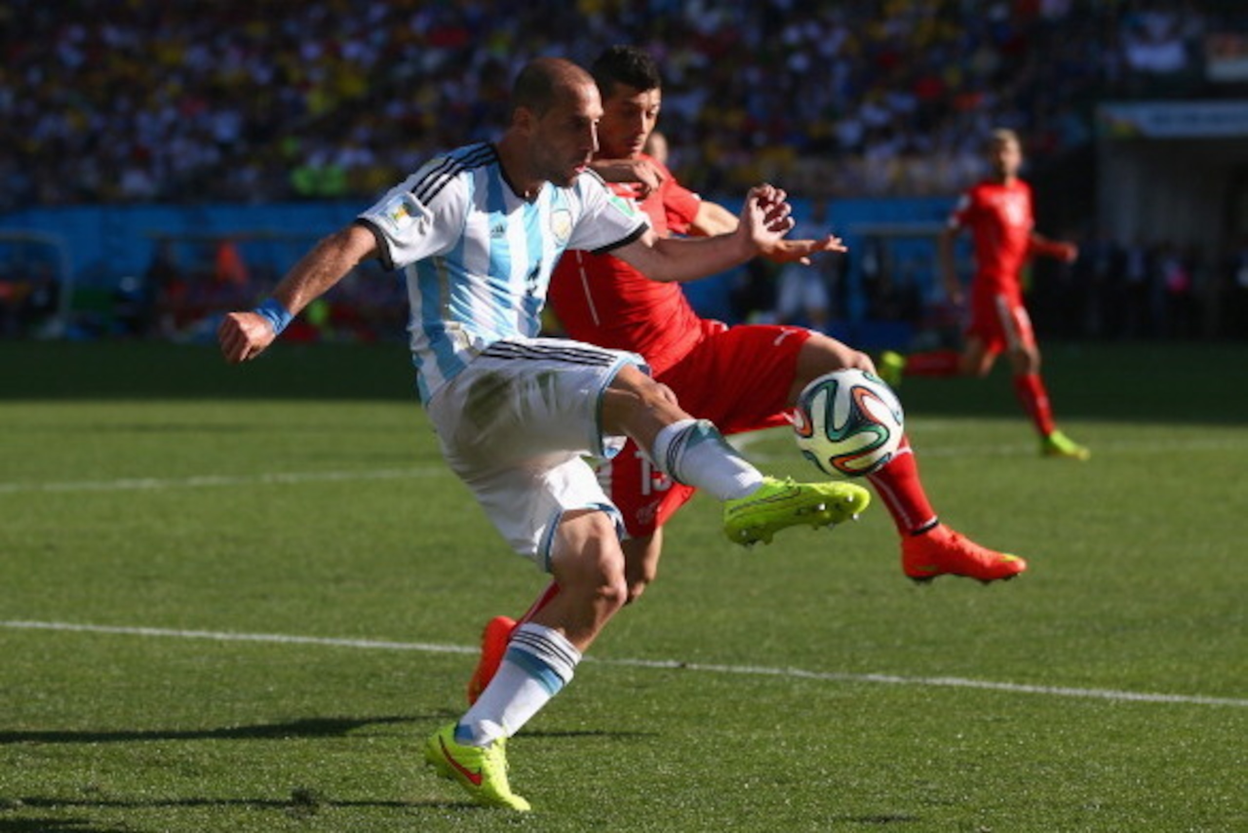 SAO PAULO, BRAZIL - JULY 01:  Pablo Zabaleta of Argentina and Blerim Dzemaili of Switzerland compete for the ball during the 2014 FIFA World Cup Brazil Round of 16 match between Argentina and Switzerland at Arena de Sao Paulo on July 1, 2014 in Sao Paulo,