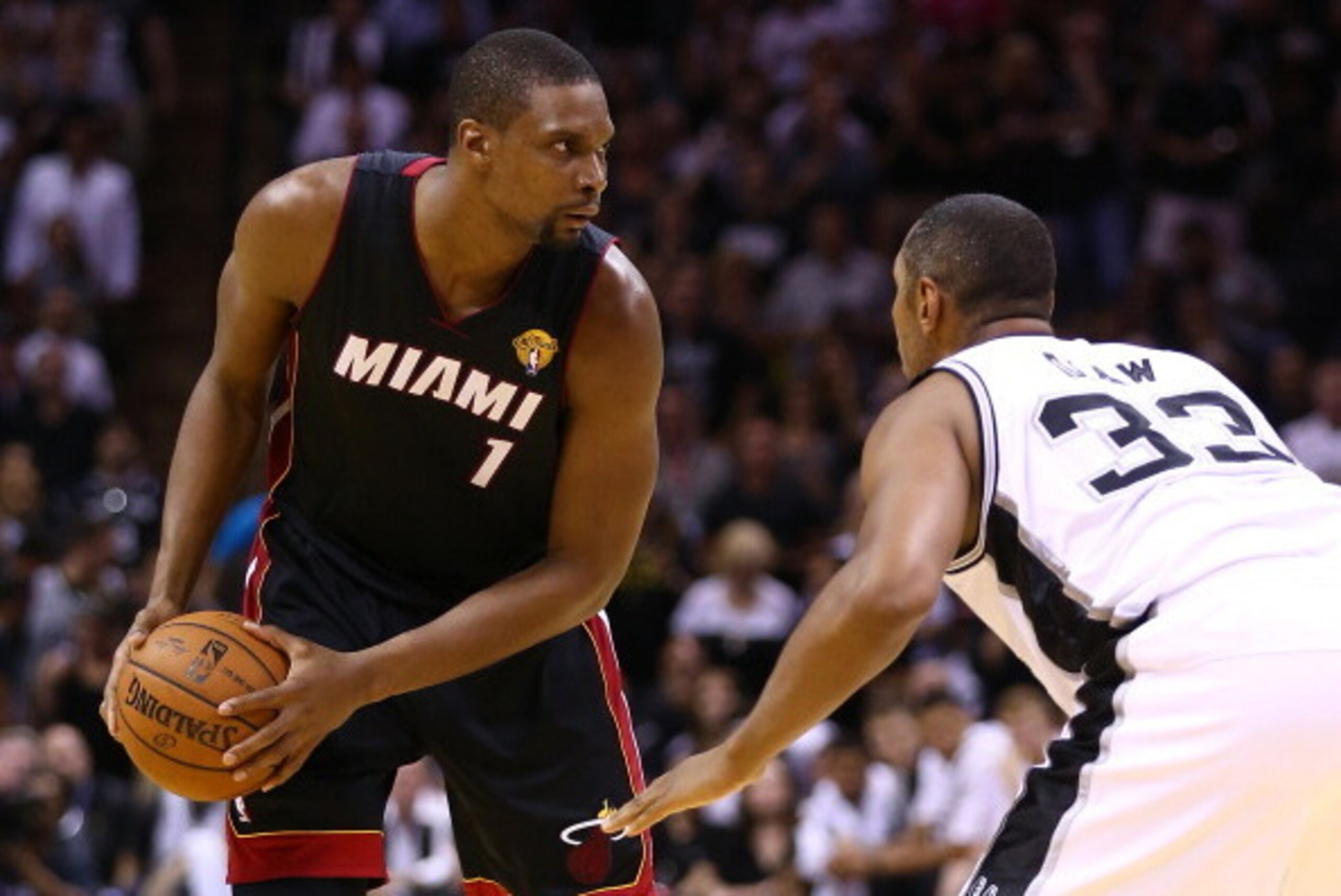 SAN ANTONIO, TX - JUNE 15: Chris Bosh #1 of the Miami Heat looks to pass as Boris Diaw #33 of the San Antonio Spurs defends during Game Five of the 2014 NBA Finals at the AT&T Center on June 15, 2014 in San Antonio, Texas. NOTE TO USER: User expressly ack