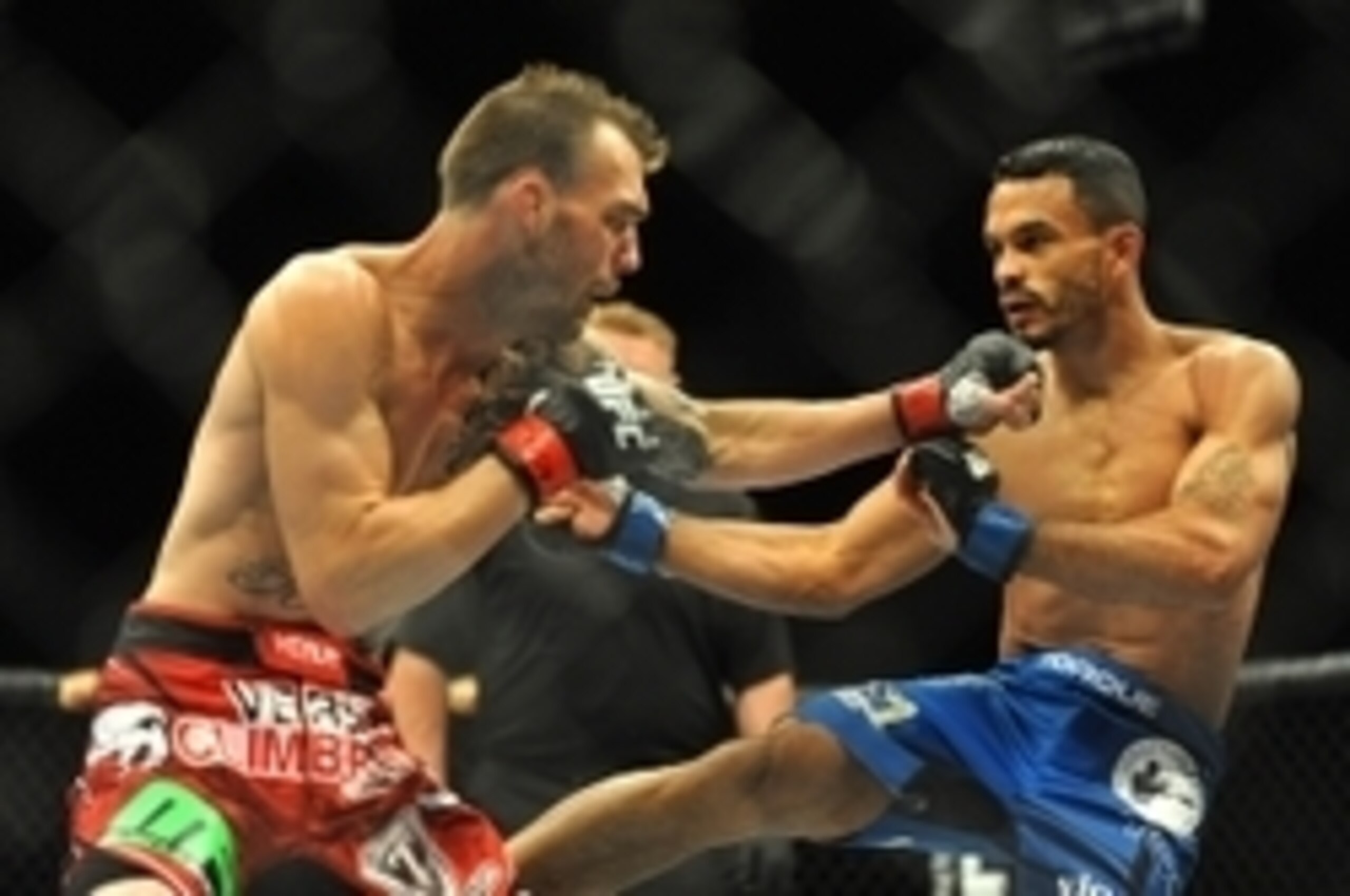 Jul 5, 2014; Las Vegas, NV, USA; George Roop (rd gloves) fights Rob Font (blue gloves) during a bantamweight fight at Mandalay Bay Events Center. Mandatory Credit: Stephen R. Sylvanie-USA TODAY Sports