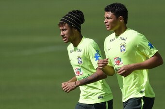 TERESOPOLIS, BRAZIL - JUNE 14: Neymar (L) and Thiago Silva run during a training session of the Brazilian national football team at the squad's Granja Comary training complex, on June 14, 2014 in Teresopolis, 90 km from downtown Rio de Janeiro, Brazil. (P