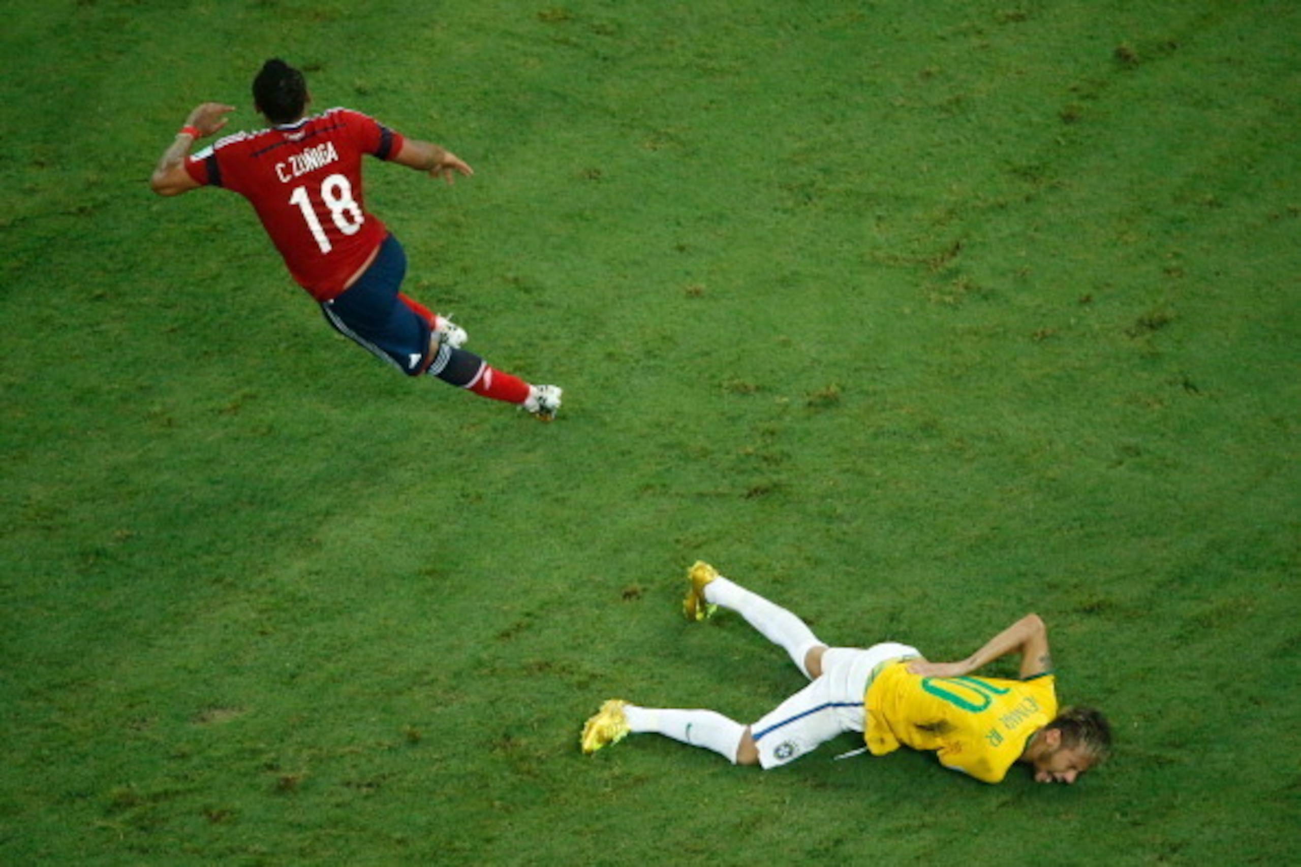 FORTALEZA, BRAZIL - JULY 04:  Neymar of Brazil lies on the pitch after a challenge by Juan Camilo Zuniga of Colombia  during the 2014 FIFA World Cup Brazil Quarter Final match between Brazil and Colombia at Castelao on July 4, 2014 in Fortaleza, Brazil.  