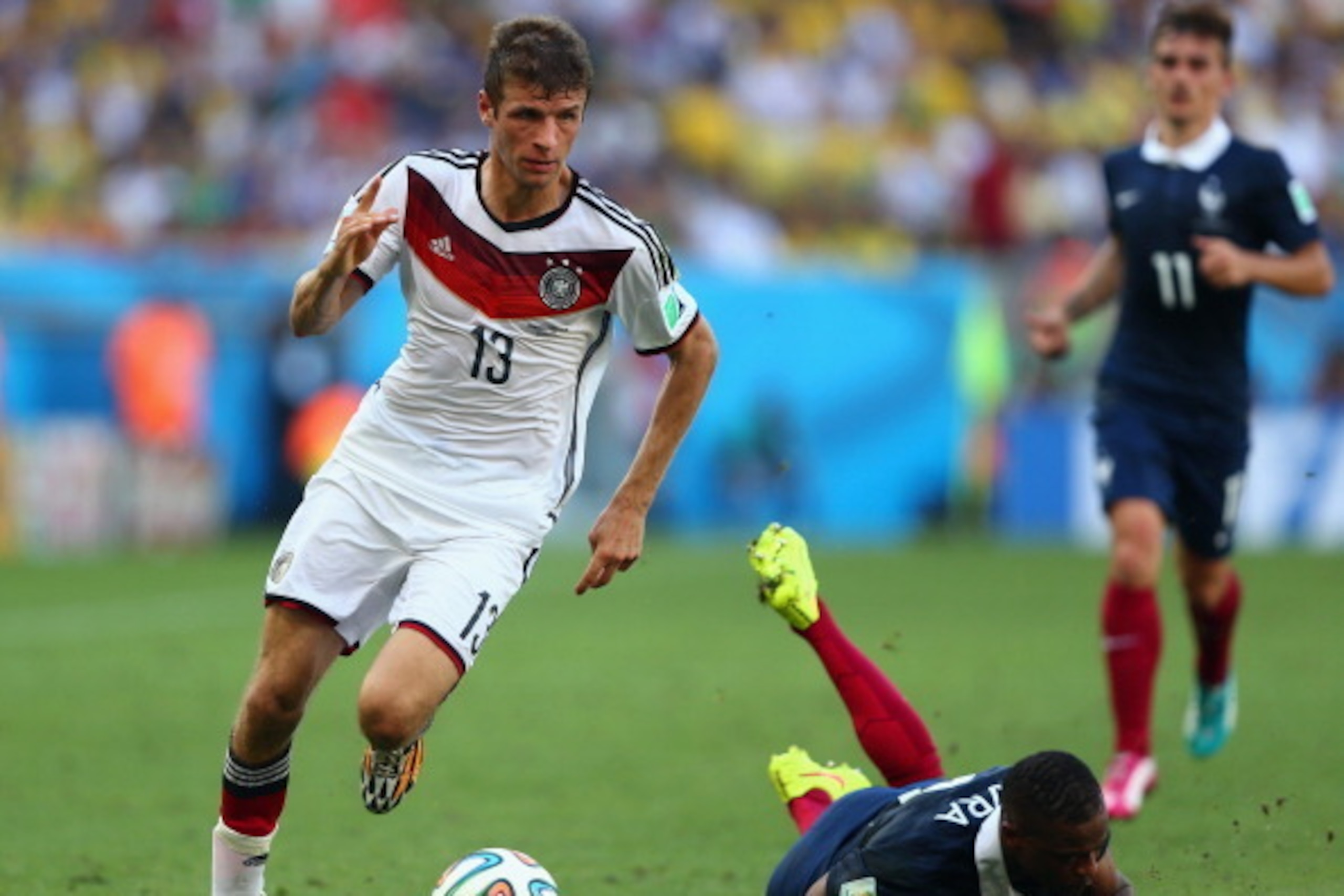 RIO DE JANEIRO, BRAZIL - JULY 04:  Thomas Mueller of Germany controls the ball as Patrice Evra of France lies on the pitch during the 2014 FIFA World Cup Brazil Quarter Final match between France and Germany at Maracana on July 4, 2014 in Rio de Janeiro, 