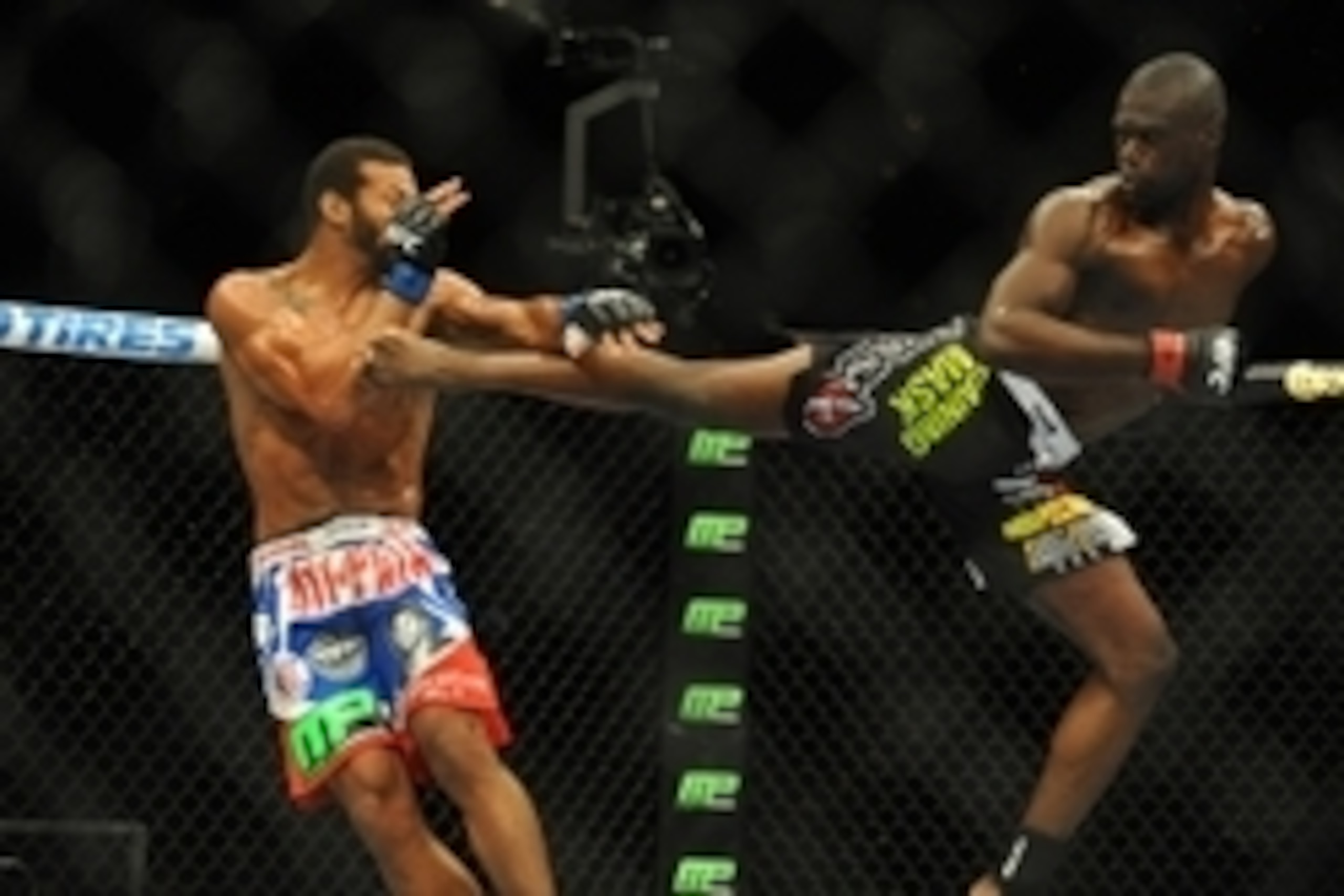 Jul 5, 2014; Las Vegas, NV, USA; Uriah Hall (red gloves) lands a kick to Thiago Santos (blue gloves) during a middleweight fight at Mandalay Bay Events Center. Mandatory Credit: Stephen R. Sylvanie-USA TODAY Sports
