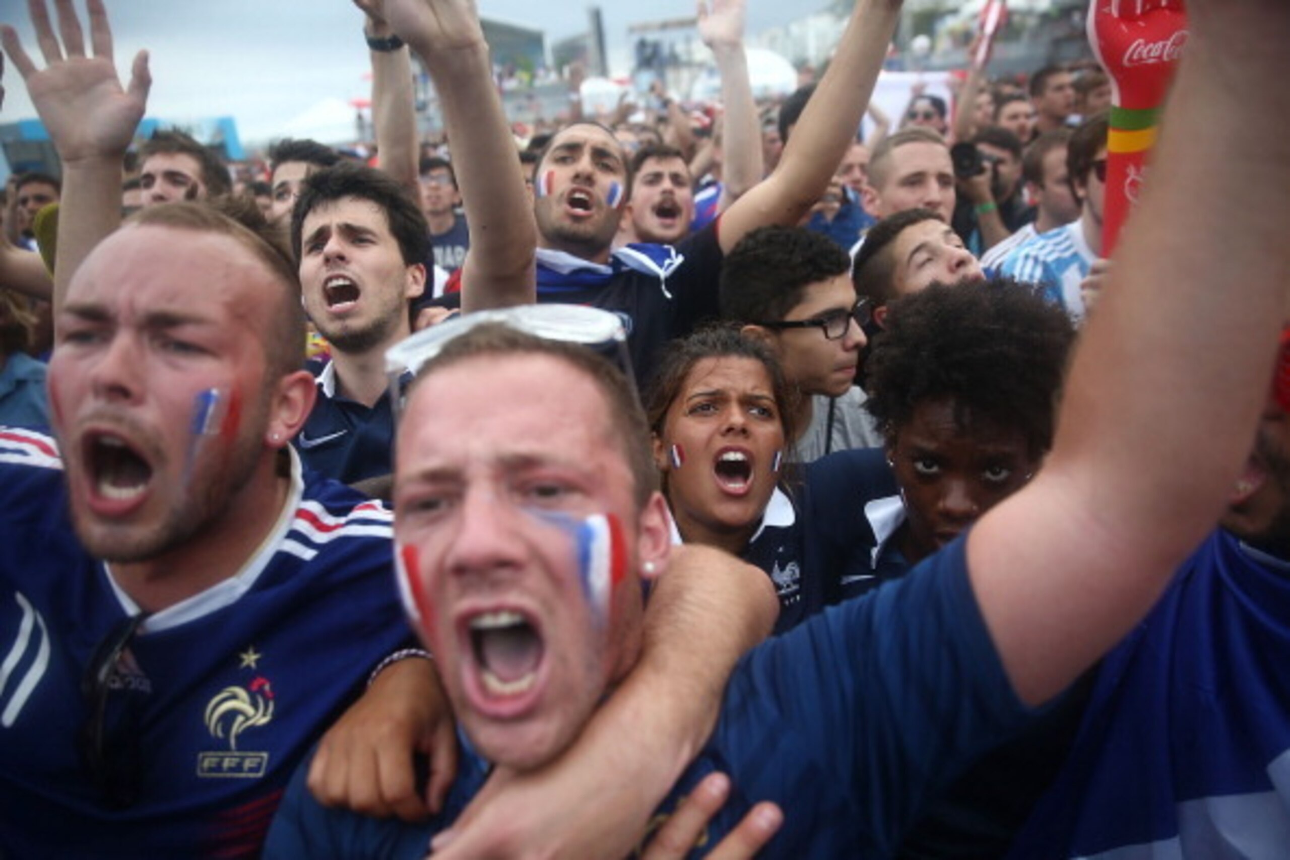 RIO DE JANEIRO, BRAZIL - JUNE 30:  France fans celebrate after their 2014 FIFA World Cup match against Nigeria while watching at FIFA Fan Fest on Copacabana Beach on June 30, 2014 in Rio de Janeiro, Brazil. France won 2-0 and advances to the quarterfinals