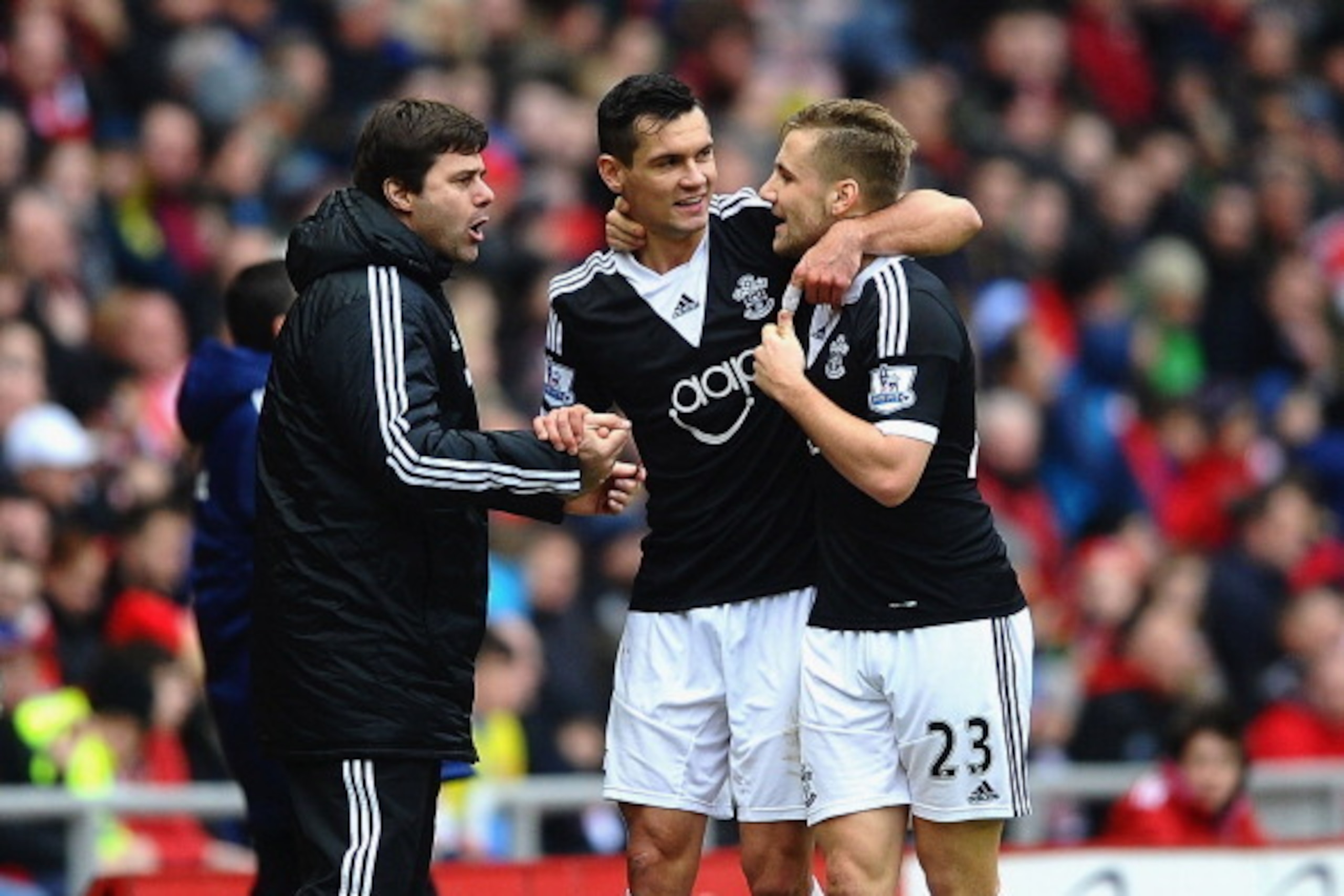 SUNDERLAND, ENGLAND - JANUARY 18:  Dejan Lovren of Southampton (C) celebrates with Mauricio Pochettino manager of Southampton (L) and Luke Shaw (23) as he scores their second goal during the Barclays Premier League match between Sunderland and Southampton