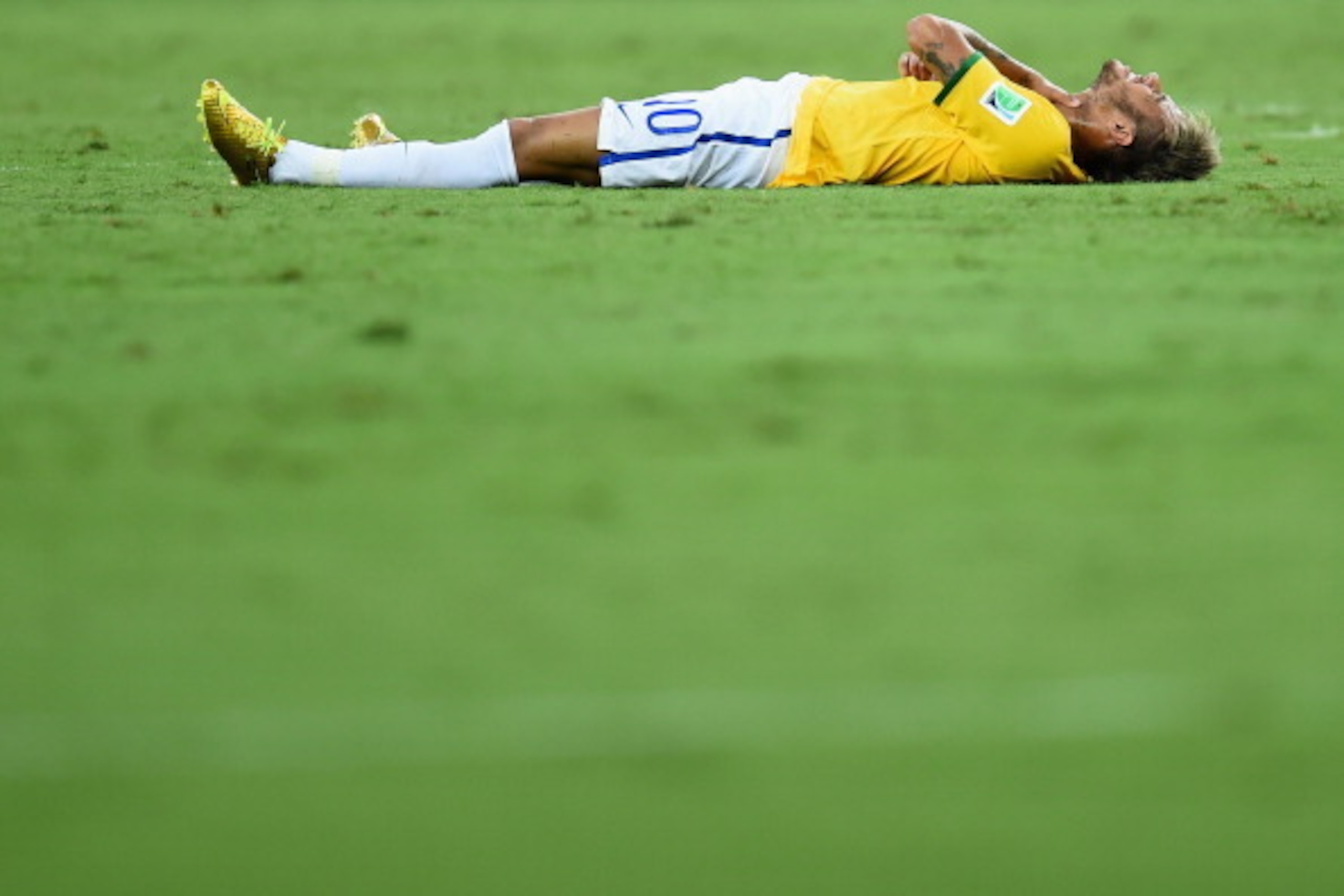 FORTALEZA, BRAZIL - JULY 04:  Neymar of Brazil lies on the field after a challenge during the 2014 FIFA World Cup Brazil Quarter Final match between Brazil and Colombia at Castelao on July 4, 2014 in Fortaleza, Brazil.  (Photo by Jamie McDonald/Getty Imag