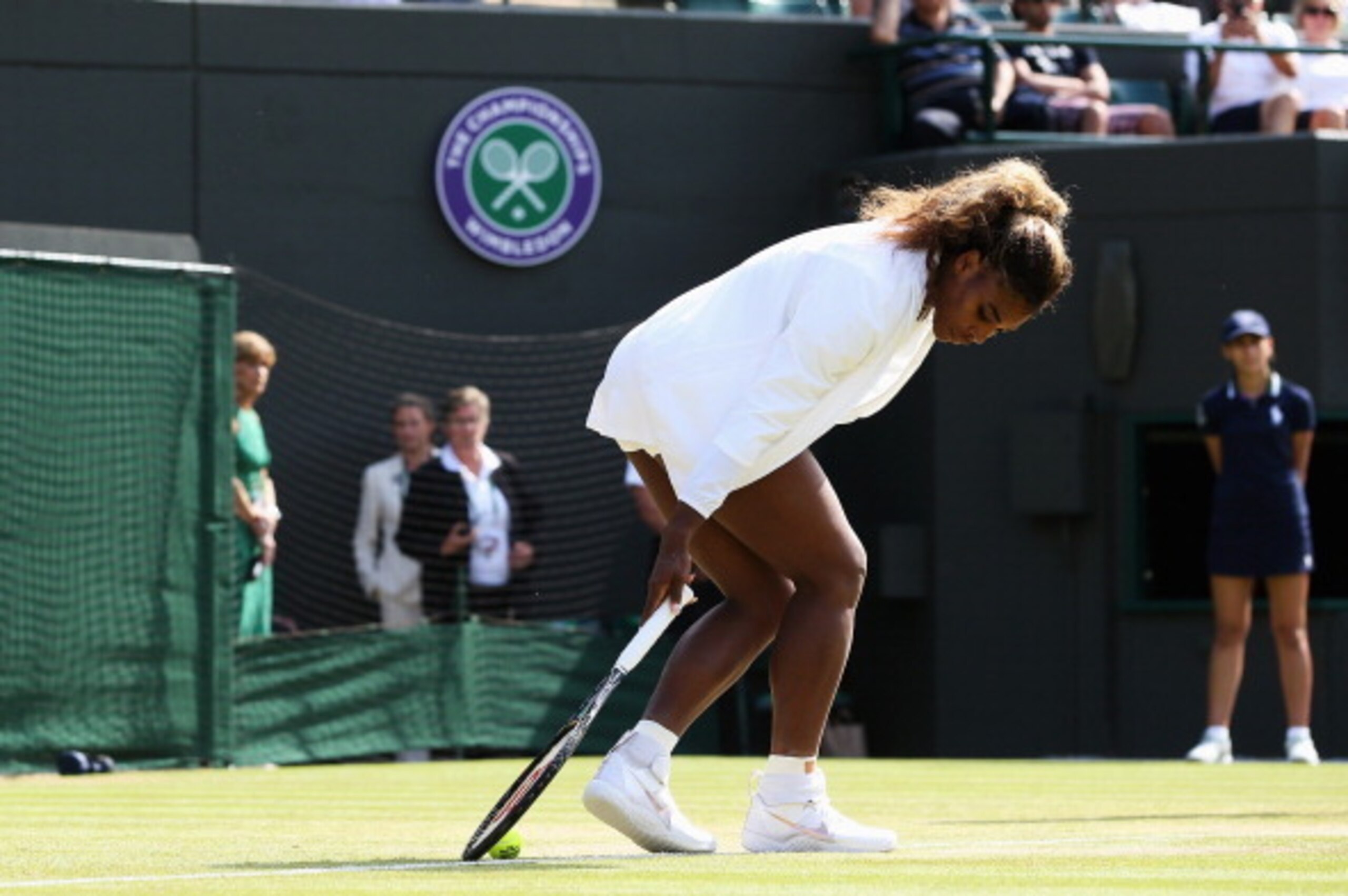 LONDON, ENGLAND - JULY 01:  Serena Williams of the United States struggles during the warm up prior her Ladies Doubles second round match with Venus against Kristina Barrois of Germany and Stefanie Voegele of Switzerland on day eight of the Wimbledon Lawn