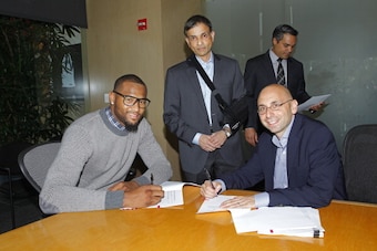 SACRAMENTO, CA - SEPTEMBER 30: Demarcus Cousins, Vivek Ranadive', and Pete D'Alessandro pose for a photo as The Sacramento Kings sign Demarcus to a contract extension on September 30, 2013 at the Kings practice facility in Sacramento, California. NOTE TO 