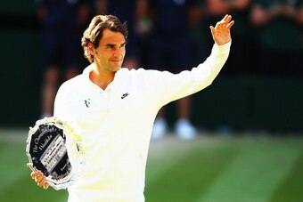 LONDON, ENGLAND - JULY 06:  Roger Federer of Switzerland waves to the fans as he holds the runner up trophy after the Gentlemen's Singles Final match against Novak Djokovic of Serbia on day thirteen of the Wimbledon Lawn Tennis Championships at the All En