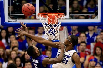 LAWRENCE, KS - JANUARY 11:  Joel Embiid #21 of the Kansas Jayhawks blocks a shot by Jevon Thomas #5 of the Kansas State Wildcats during the game at Allen Fieldhouse on January 11, 2014 in Lawrence, Kansas.  (Photo by Jamie Squire/Getty Images)
