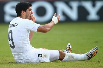 NATAL, BRAZIL - JUNE 24:  Luis Suarez of Uruguay reacts after a clash during the 2014 FIFA World Cup Brazil Group D match between Italy and Uruguay at Estadio das Dunas on June 24, 2014 in Natal, Brazil.  (Photo by Clive Rose/Getty Images)