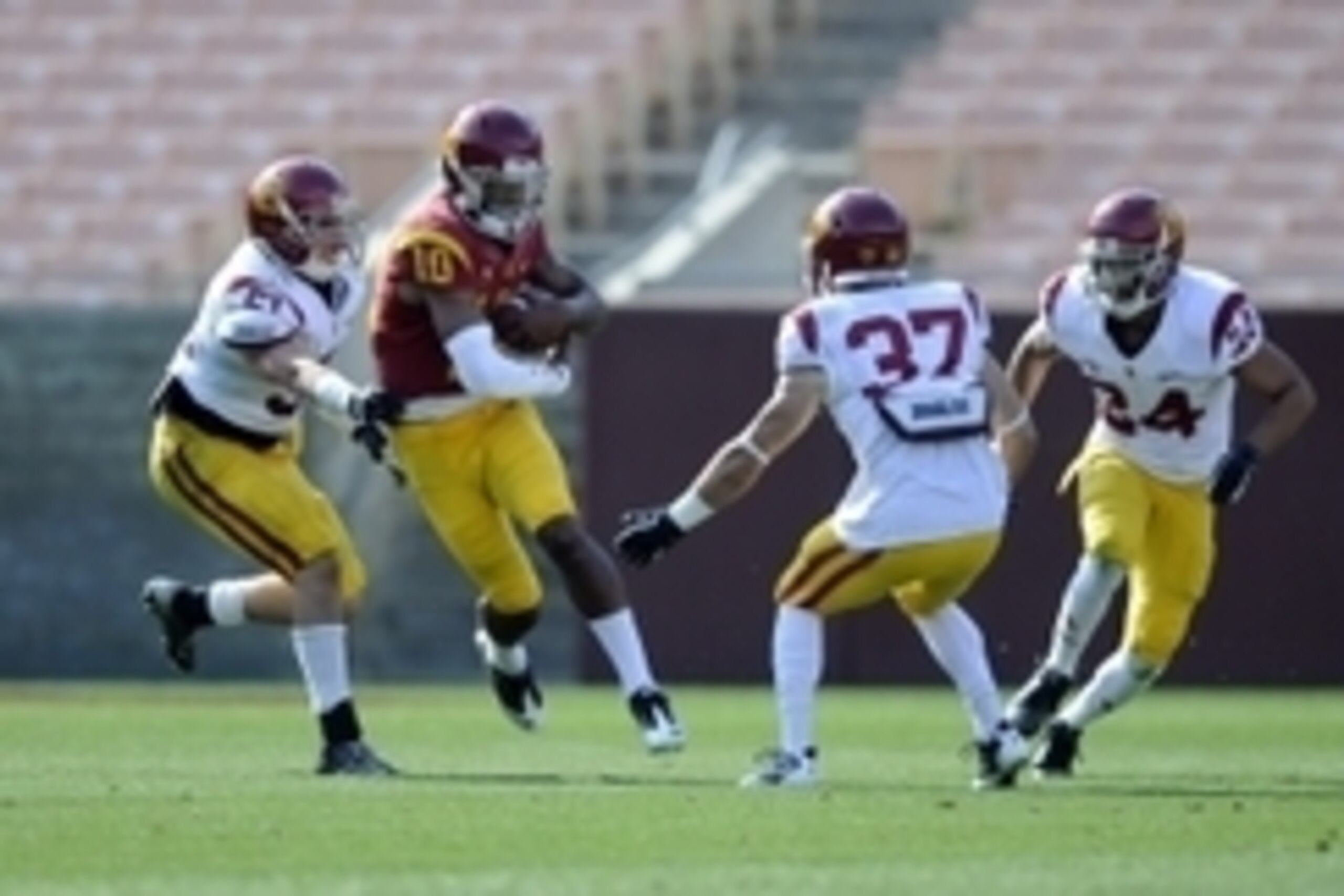 Apr 19, 2014; Los Angeles, CA, USA; Southern California quarterback Jalen Greene (10) moves the ball defended by Southern California inside linebacker Joel Foy (51) during the Southern California Spring Game at Los Angeles Memorial Coliseum. Mandatory Cre