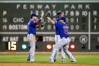 BOSTON, MA - JULY 1:  Chris Coghlan #8, Junior Lake #21, and Justin Ruggiano #20 of the Chicago Cubs celebrate their 2-1 win over the Boston Red Sox at Fenway Park on July 1, 2014 in Boston, Massachusetts.  (Photo by Jim Rogash/Getty Images)