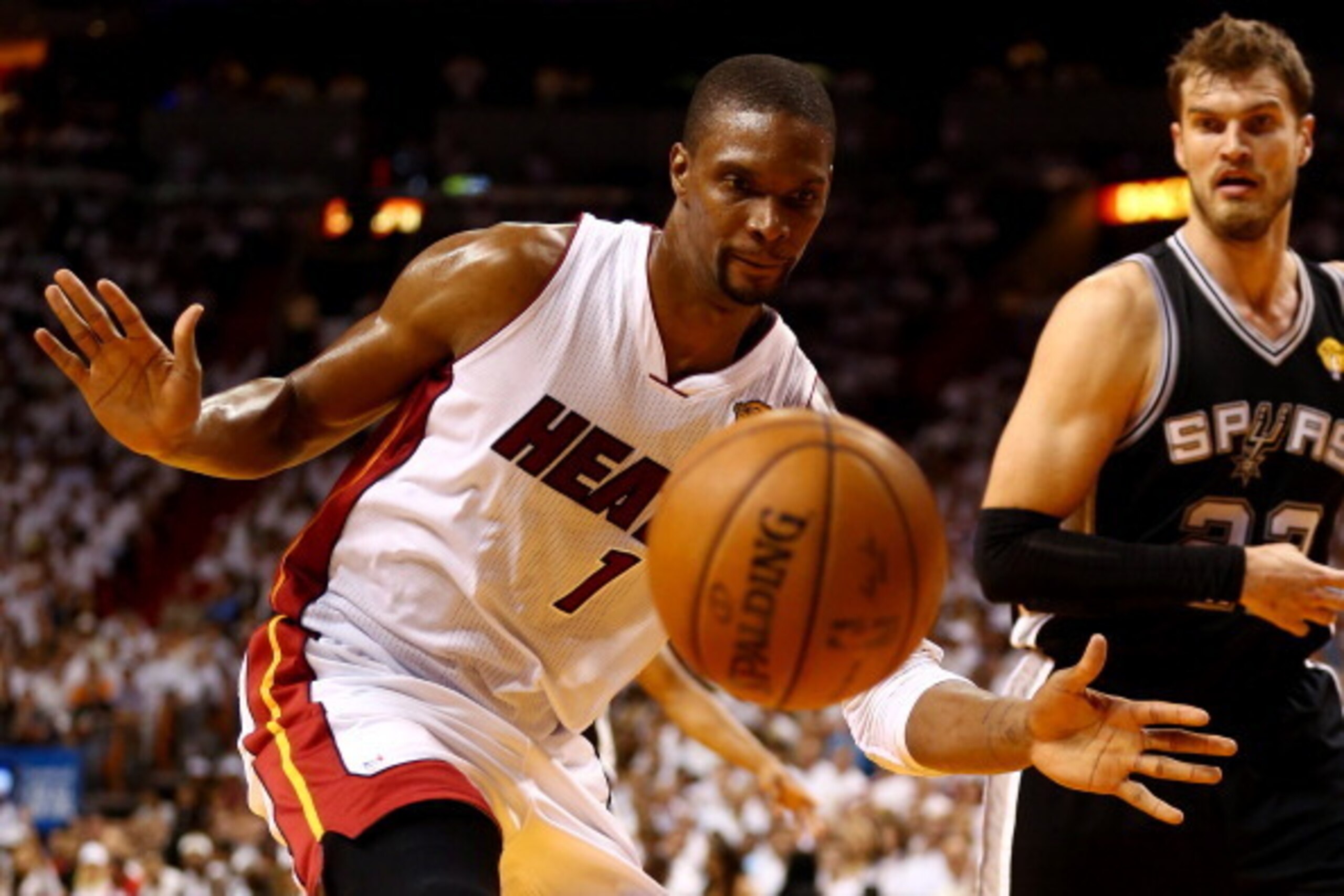 MIAMI, FL - JUNE 12: Chris Bosh #1 of the Miami Heat loses the ball as Tiago Splitter #22 of the San Antonio Spurs defends during Game Four of the 2014 NBA Finals at American Airlines Arena on June 12, 2014 in Miami, Florida. NOTE TO USER: User expressly 
