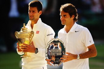 LONDON, ENGLAND - JULY 06:  Novak Djokovic of Serbia poses with the Gentlemen's Singles Trophy next to Roger Federer of Switzerland following his victory in the Gentlemen's Singles Final match on day thirteen of the Wimbledon Lawn Tennis Championships at 