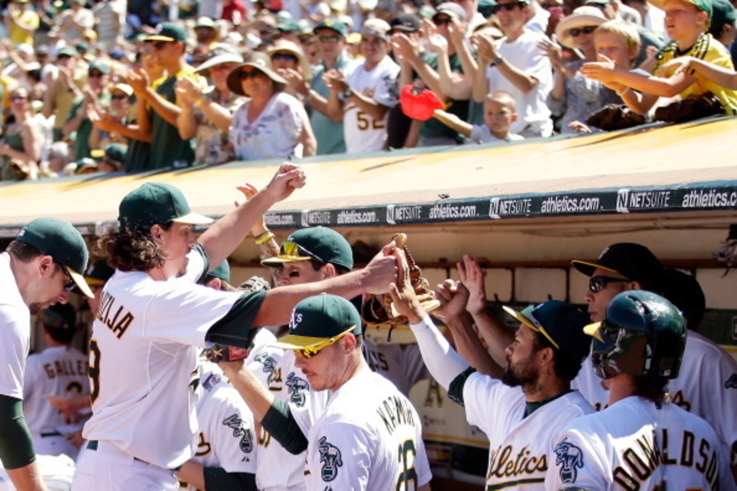 OAKLAND, CA - JULY 06:  Jeff Samardzija #29 of the Oakland Athletics is congratulated by teammates after he struck out three batters in a row in the seventh inning of their game against the Toronto Blue Jays at O.co Coliseum on July 6, 2014 in Oakland, Ca