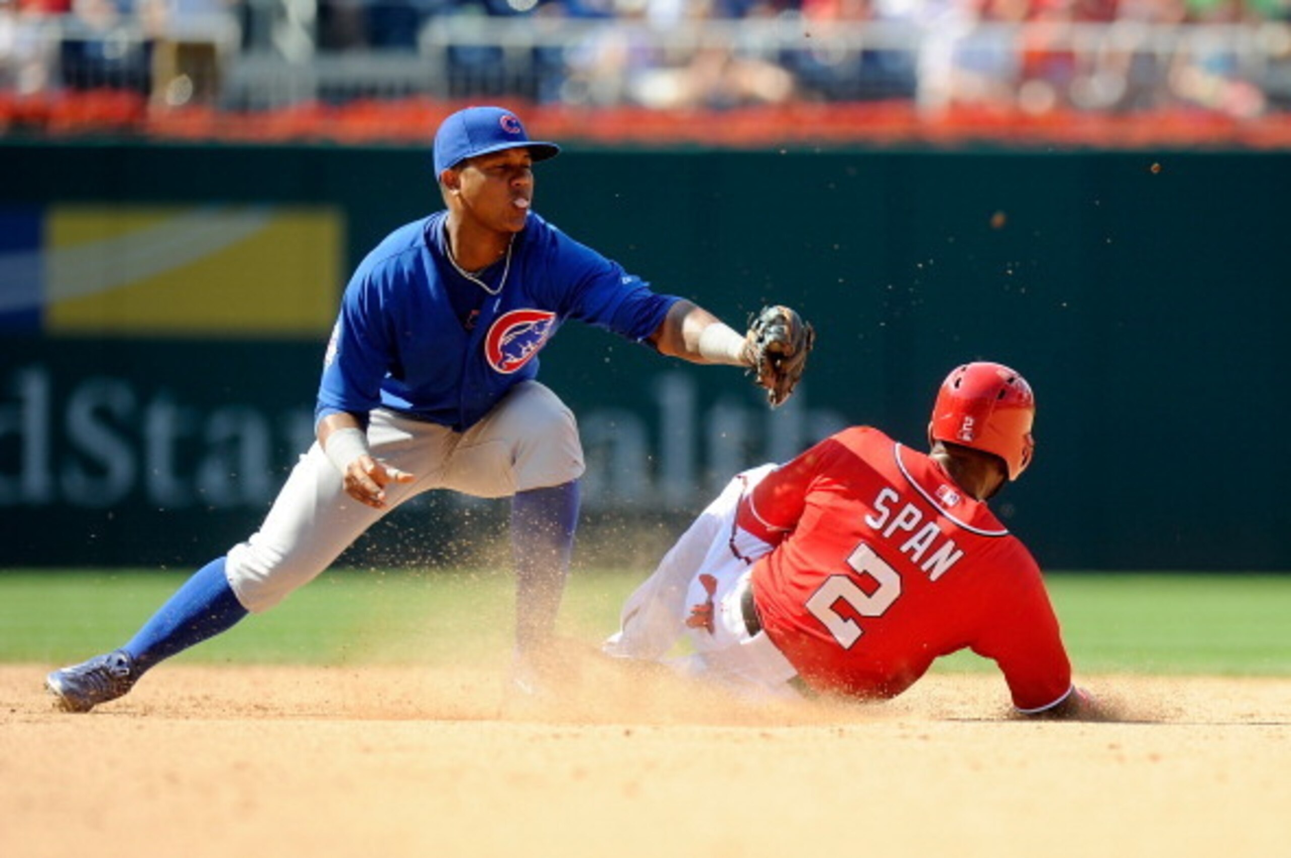 WASHINGTON, DC - JULY 06:  Denard Span #2 of the Washington Nationals slides into second base for a double in the eighth inning under the tag of Starlin Castro #13 of the Chicago Cubs at Nationals Park on July 6, 2014 in Washington, DC. Washington won the