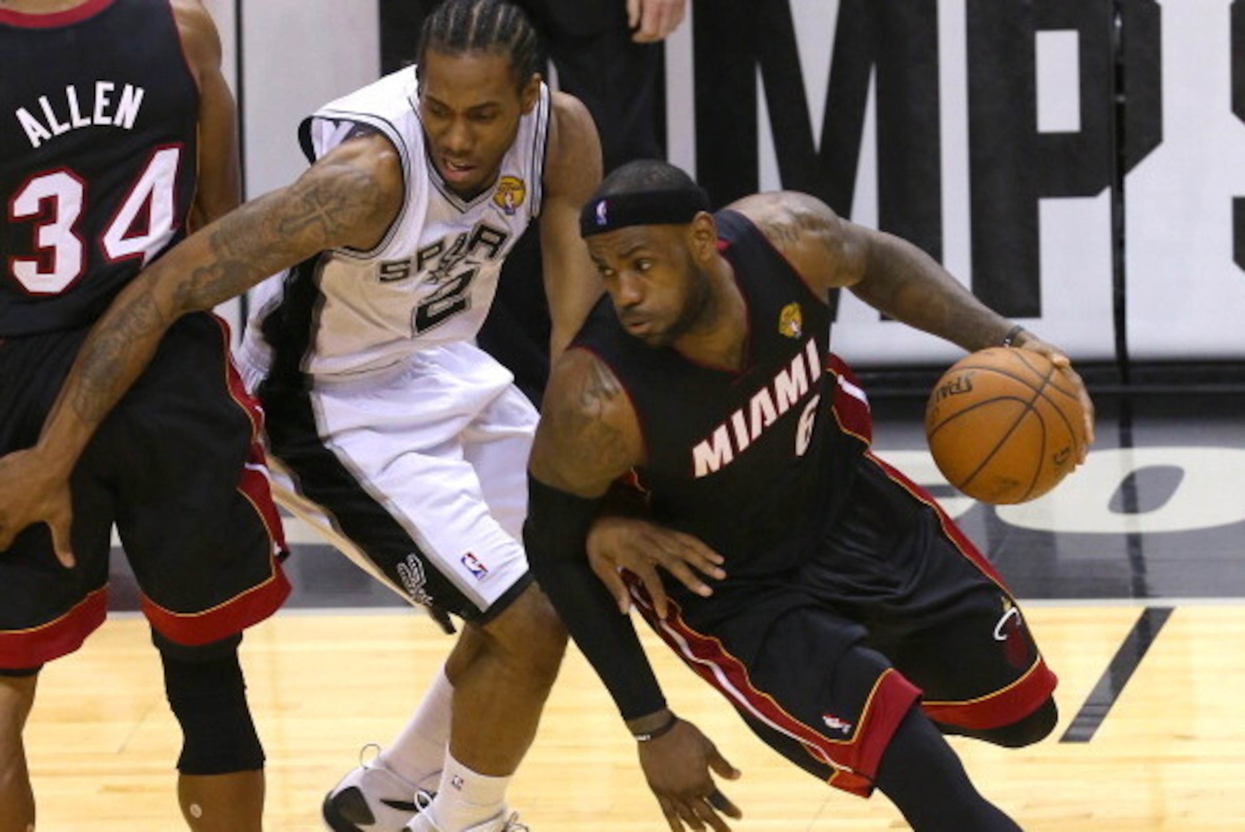 SAN ANTONIO, TX - JUNE 15:  LeBron James #6 of the Miami Heat drives around Kawhi Leonard #2 of the San Antonio Spurs in Game Five of the 2014 NBA Finals at the AT&T Center on June 15, 2014 in San Antonio, Texas. NOTE TO USER: User expressly acknowledges 