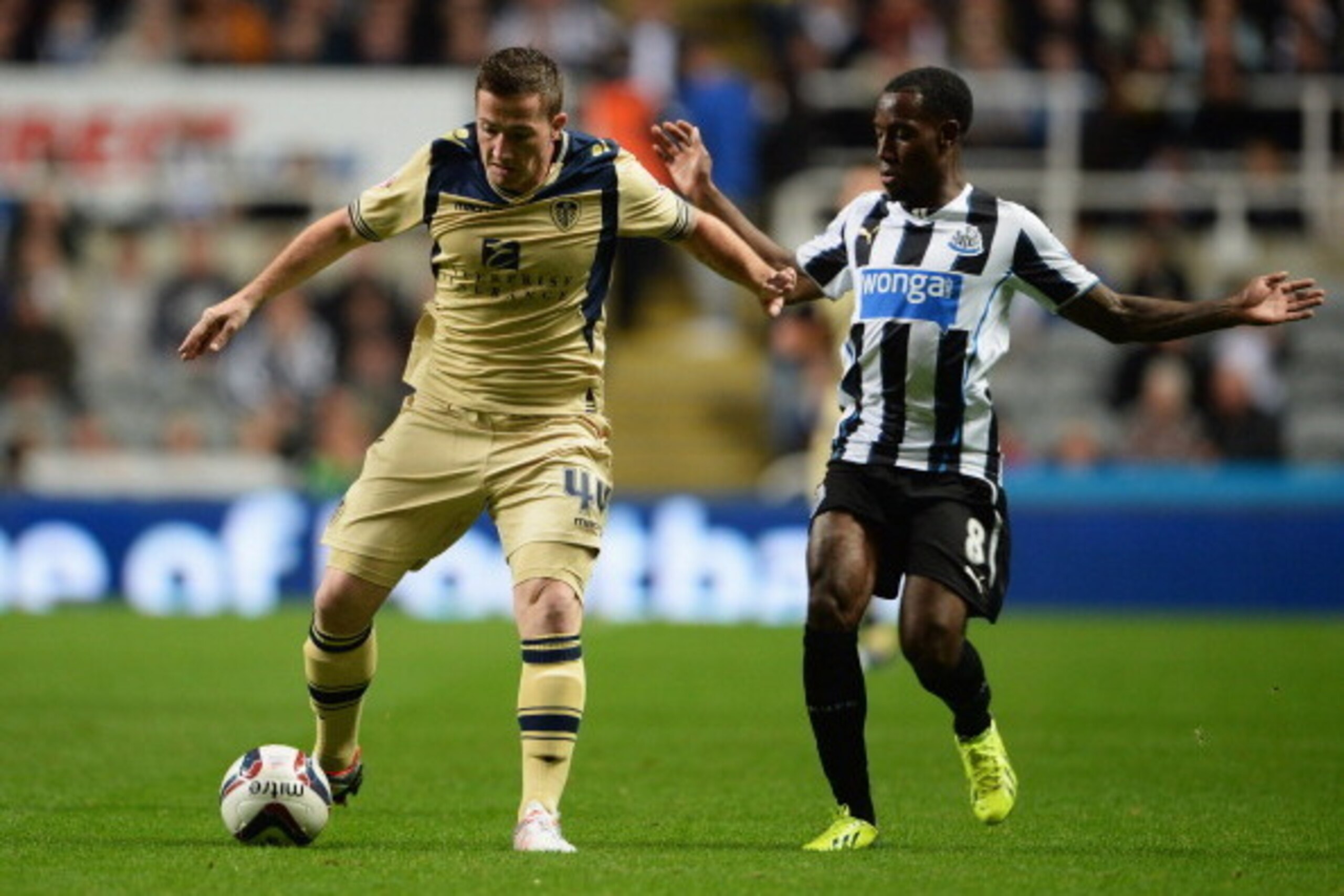 NEWCASTLE UPON TYNE, ENGLAND - SEPTEMBER 25:  Ross McCormack of Leeds United holds off Vurnon Anita of Newcastle United during the Capital One Cup Third Round match between Newcastle United and Leeds United at St James' Park on September 25, 2013 in Newca