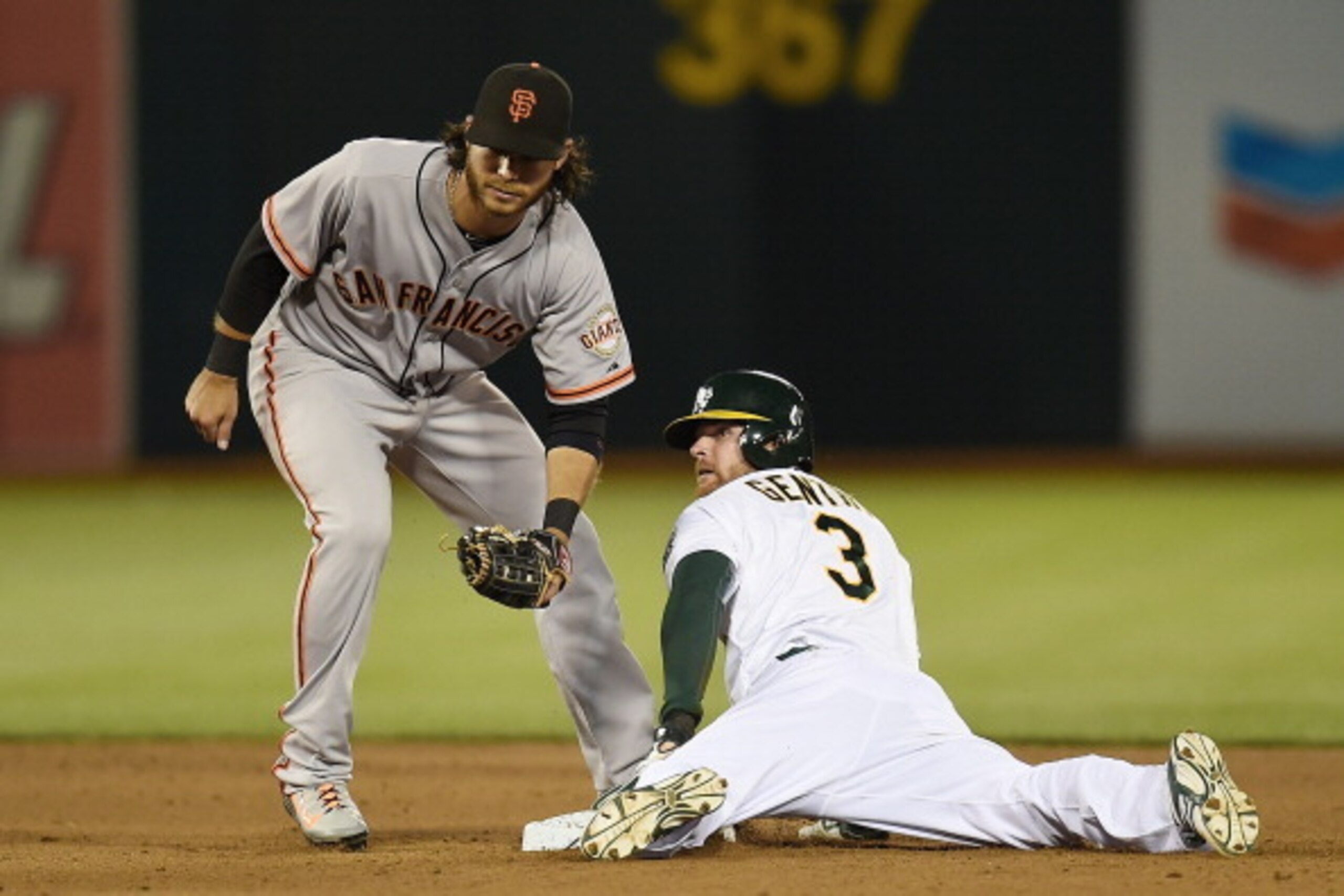 OAKLAND, CA - JULY 07:  Craig Gentry #3 of the Oakland Athletics steals second base, beating the throw to Brandon Crawford #35 of the San Francisco Giants in the bottom of the fifth inning at O.co Coliseum on July 7, 2014 in Oakland, California.  (Photo b
