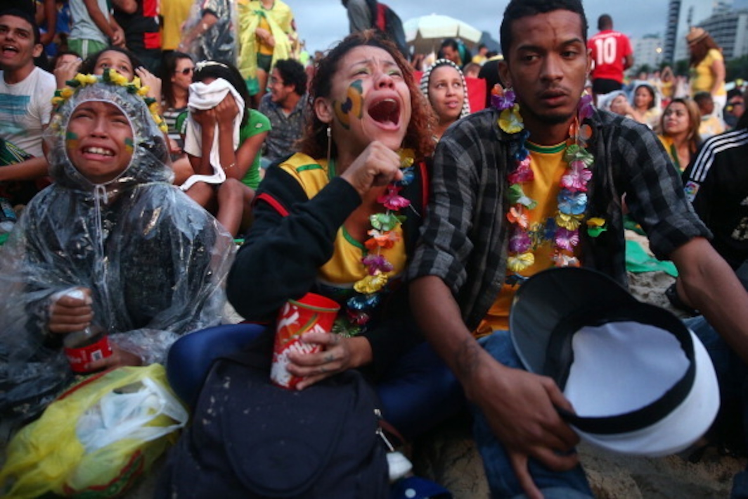 RIO DE JANEIRO, BRAZIL - JULY 08:  Brazil fans are devastated while watching the first half on Copacabana Beach during the 2014 FIFA World Cup semi-final match between Brazil and Germany on July 8, 2014 in Rio de Janeiro, Brazil. The winner advances to th