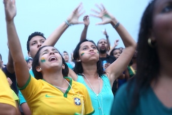 RIO DE JANEIRO, BRAZIL - JULY 08:  Brazil fans watch the first half on Copacabana Beach during the 2014 FIFA World Cup semi-final match between Brazil and Germany on July 8, 2014 in Rio de Janeiro, Brazil. The winner advances to the final at the famed Mar