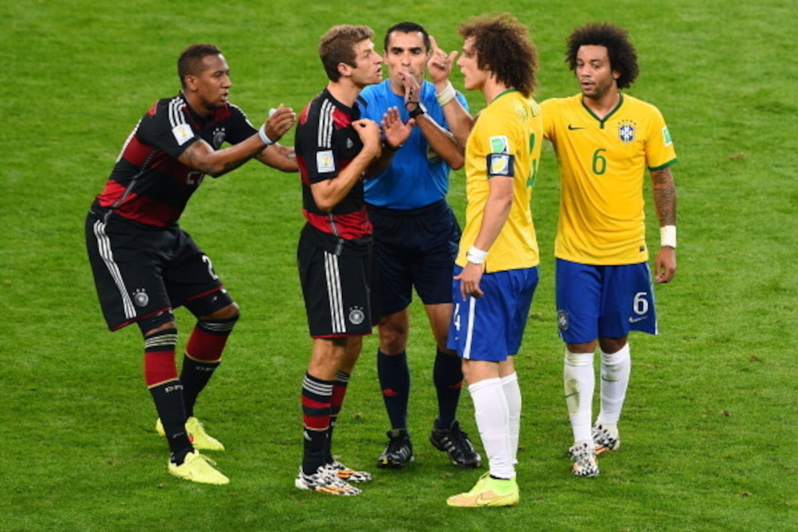 BELO HORIZONTE, BRAZIL - JULY 08:  Referee Marco Rodriguez separates a clash between Jerome Boateng and Thomas Mueller of Germany and David Luiz and Marcelo of Brazil during the 2014 FIFA World Cup Brazil Semi Final match between Brazil and Germany at Est