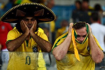 BELO HORIZONTE, BRAZIL - JULY 08:  Emotional Brazil fans react after being defeated by Germany 7-1 during the 2014 FIFA World Cup Brazil Semi Final match between Brazil and Germany at Estadio Mineirao on July 8, 2014 in Belo Horizonte, Brazil.  (Photo by 
