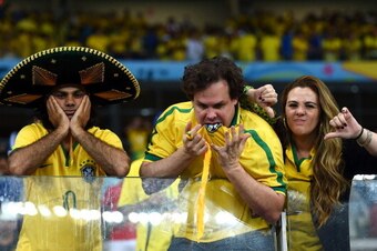 BELO HORIZONTE, BRAZIL - JULY 08:  Emotional Brazil fans react after being defeated by Germany 7-1 during the 2014 FIFA World Cup Brazil Semi Final match between Brazil and Germany at Estadio Mineirao on July 8, 2014 in Belo Horizonte, Brazil.  (Photo by 