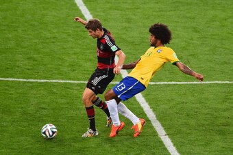 BELO HORIZONTE, BRAZIL - JULY 08:Thomas Mueller of Germany is challenged by Dante of Brazil during the 2014 FIFA World Cup Brazil Semi Final match between Brazil and Germany at Estadio Mineirao on July 8, 2014 in Belo Horizonte, Brazil.  (Photo by Jamie M
