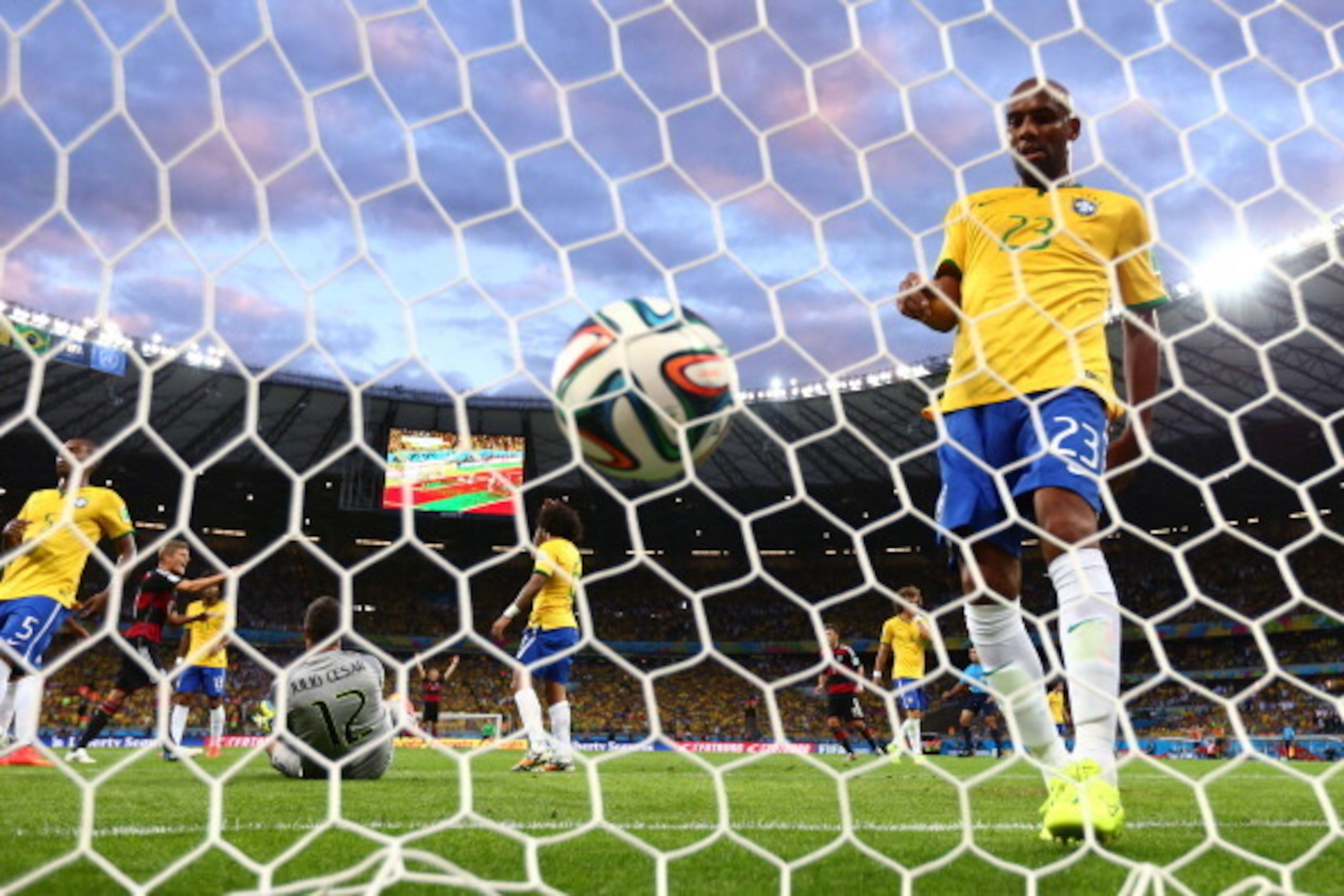 BELO HORIZONTE, BRAZIL - JULY 08: Maicon of Brazil retrieves the ball from the net after Germany's second goal by Miroslav Klose (not pictured) past goalkeeper Julio Cesar during the 2014 FIFA World Cup Brazil Semi Final match between Brazil and Germany a BELO HORIZONTE, BRAZIL - JULY 08: Maicon of Brazil retrieves the ball from the net after Germany's second goal by Miroslav Klose (not pictured) past goalkeeper Julio Cesar during the 2014 FIFA World Cup Brazil Semi Final match between Brazil and Germany a