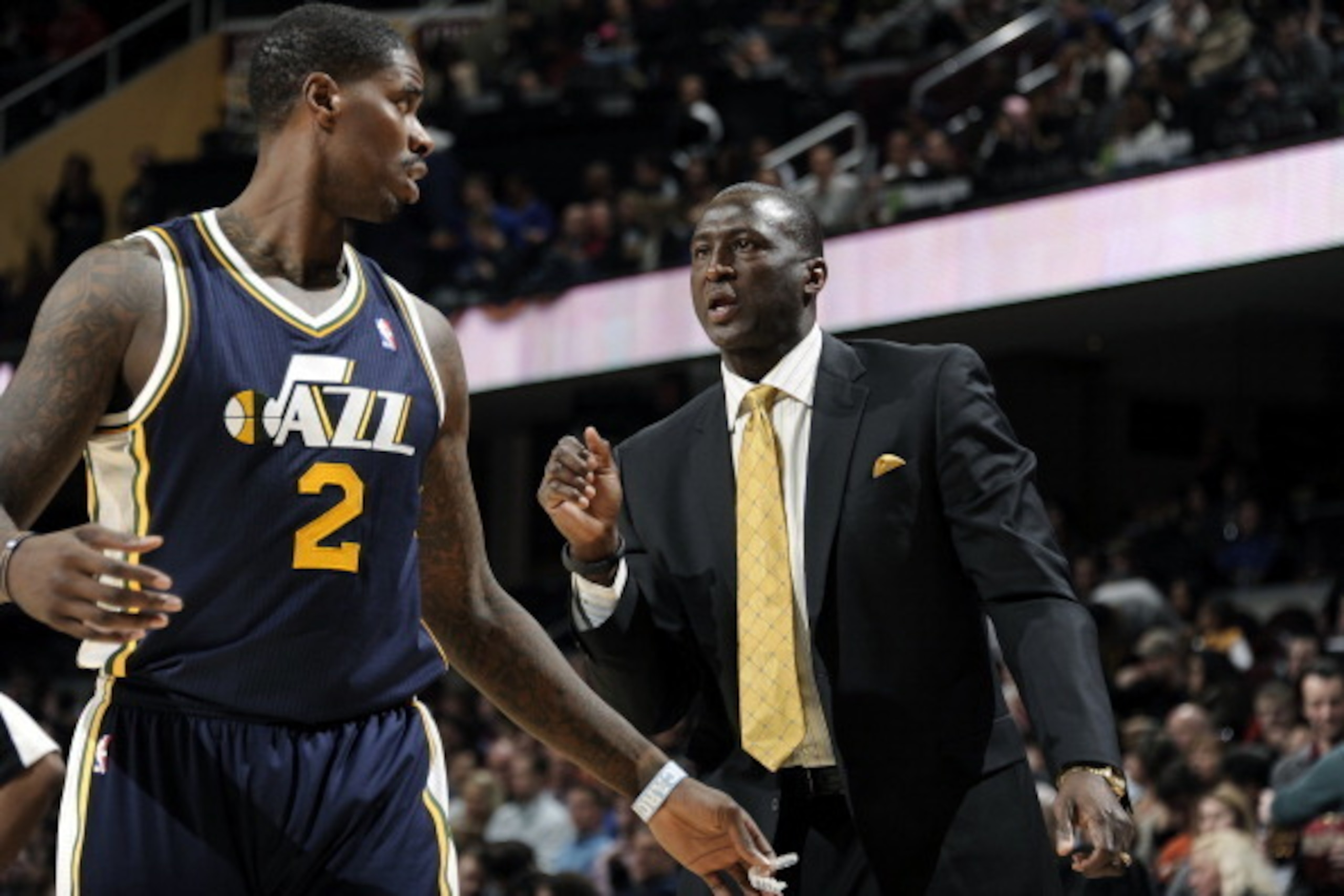 CLEVELAND, OH - FEBRUARY 28:  Head Coach Tyrone Corbin of the Utah Jazz talks to Marvin Williams #2 on the sideline against the Cleveland Cavaliers at The Quicken Loans Arena on February 28, 2014 in Cleveland, Ohio. NOTE TO USER: User expressly acknowledg