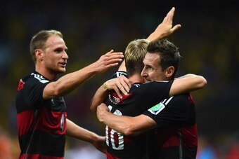 BELO HORIZONTE, BRAZIL - JULY 08: Toni Kroos of Germany (C) celebrates scoring his team's third goal with Benedikt Hoewedes (L) and Miroslav Klose during the 2014 FIFA World Cup Brazil Semi Final match between Brazil and Germany at Estadio Mineirao on Jul