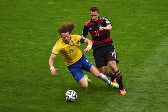 BELO HORIZONTE, BRAZIL - JULY 08:  David Luiz of Brazil is challenged by Miroslav Klose of Germany during the 2014 FIFA World Cup Brazil Semi Final match between Brazil and Germany at Estadio Mineirao on July 8, 2014 in Belo Horizonte, Brazil.  (Photo by 