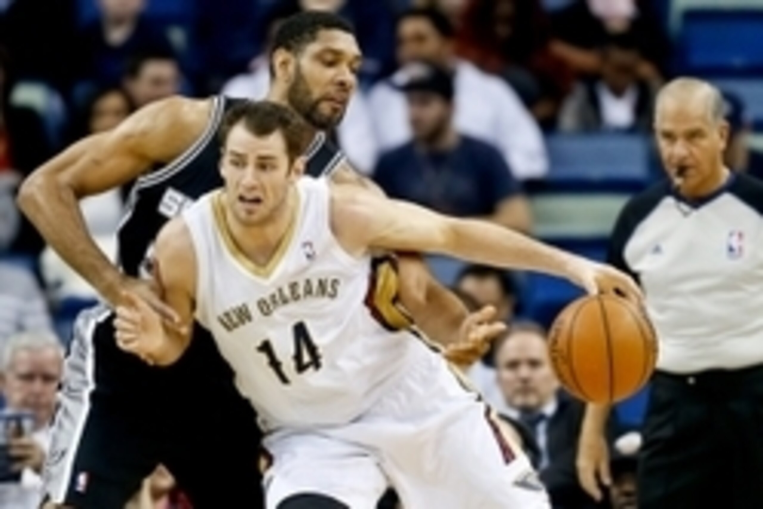 Jan 13, 2014; New Orleans, LA, USA; New Orleans Pelicans center Jason Smith (14) is guarded by San Antonio Spurs power forward Tim Duncan (21) during the first quarter of a game at the New Orleans Arena. Mandatory Credit: Derick E. Hingle-USA TODAY Sports