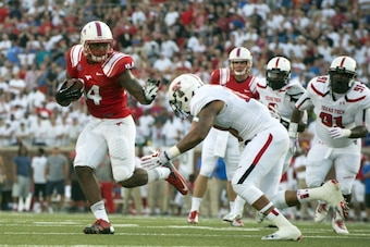 DALLAS, TX - AUGUST 30: Traylon Shead #34 of the Southern Methodist Mustangs breaks a tackle against the Texas Tech Red Raiders on August 30, 2013 at Gerald J. Ford Stadium in Dallas, Texas.  (Photo by Cooper Neill/Getty Images)