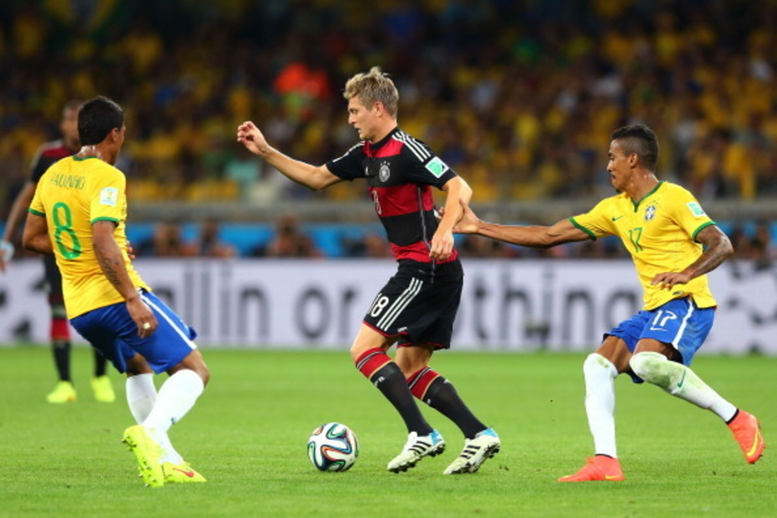 BELO HORIZONTE, BRAZIL - JULY 08:  Toni Kroos of Germany controls the ball as Luiz Gustavo of Brazil give chase during the 2014 FIFA World Cup Brazil Semi Final match between Brazil and Germany at Estadio Mineirao on July 8, 2014 in Belo Horizonte, Brazil