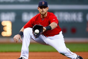 BOSTON, MA - MAY 16: Will Middlebrooks #16 of the Boston Red Sox attempts to grab a ground ball in the first inning against the Detroit Tigers during the game at Fenway Park on May 16, 2014 in Boston, Massachusetts.  (Photo by Jared Wickerham/Getty Images