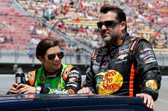 BROOKLYN, MI - JUNE 15:  Danica Patrick, driver of the #10 GoDaddy Chevrolet, and Tony Stewart, driver of the #14 Bass Pro Shops / Mobil 1 Chevrolet, ride down pit road prior to the NASCAR Sprint Cup Series Quicken Loans 400 at Michigan International Spee