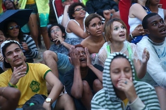 RIO DE JANEIRO, BRAZIL - JULY 08:  Brazil fans watch the first half on Copacabana Beach during the 2014 FIFA World Cup semi-final match between Brazil and Germany on July 8, 2014 in Rio de Janeiro, Brazil. The winner advances to the final at the famed Mar