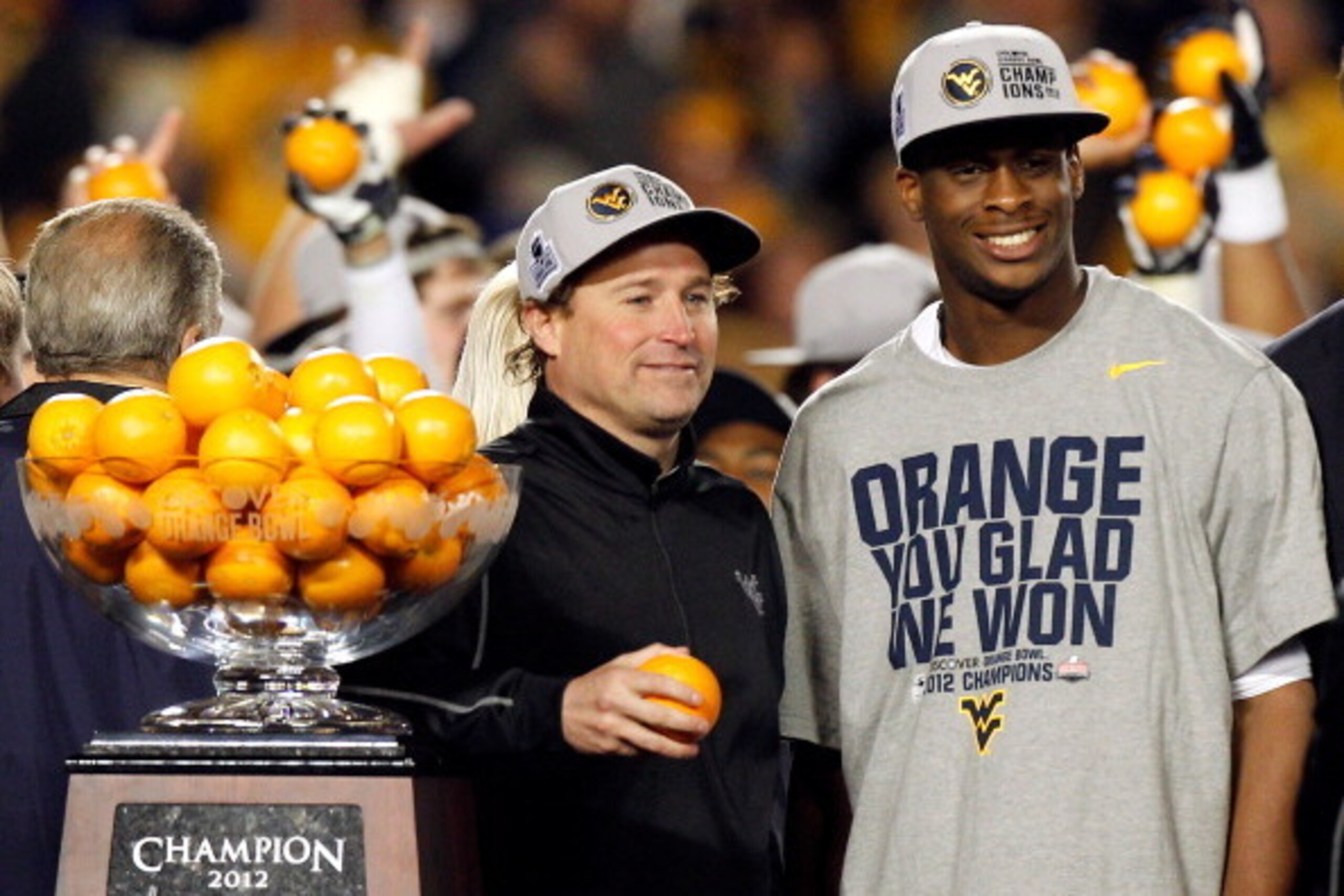 MIAMI GARDENS, FL - JANUARY 04:  (L-R) Head coach Dana Holgorsen and Geno Smith #12 of the West Virginia Mountaineers celebrate after they won 70-33 against the Clemson Tigers during the Discover Orange Bowl at Sun Life Stadium on January 4, 2012 in Miami