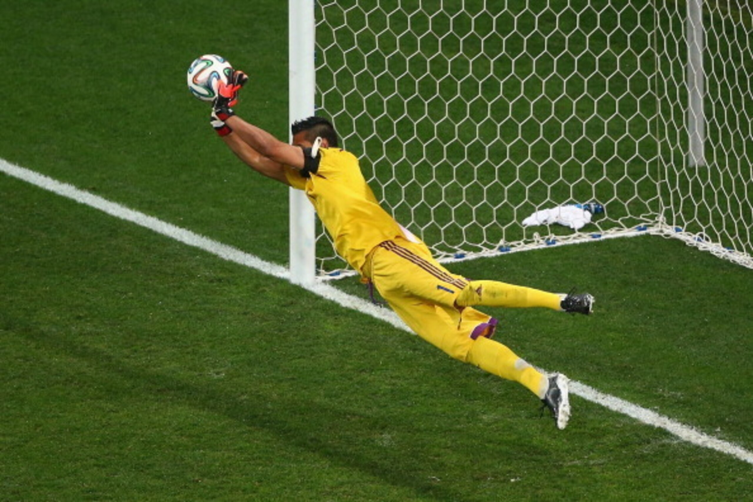 SAO PAULO, BRAZIL - JULY 09: Sergio Romero of Argentina saves the penalty kick of Wesley Sneijder of the Netherlands (not pictured) in a shootout during the 2014 FIFA World Cup Brazil Semi Final match between the Netherlands and Argentina at Arena de Sao 
