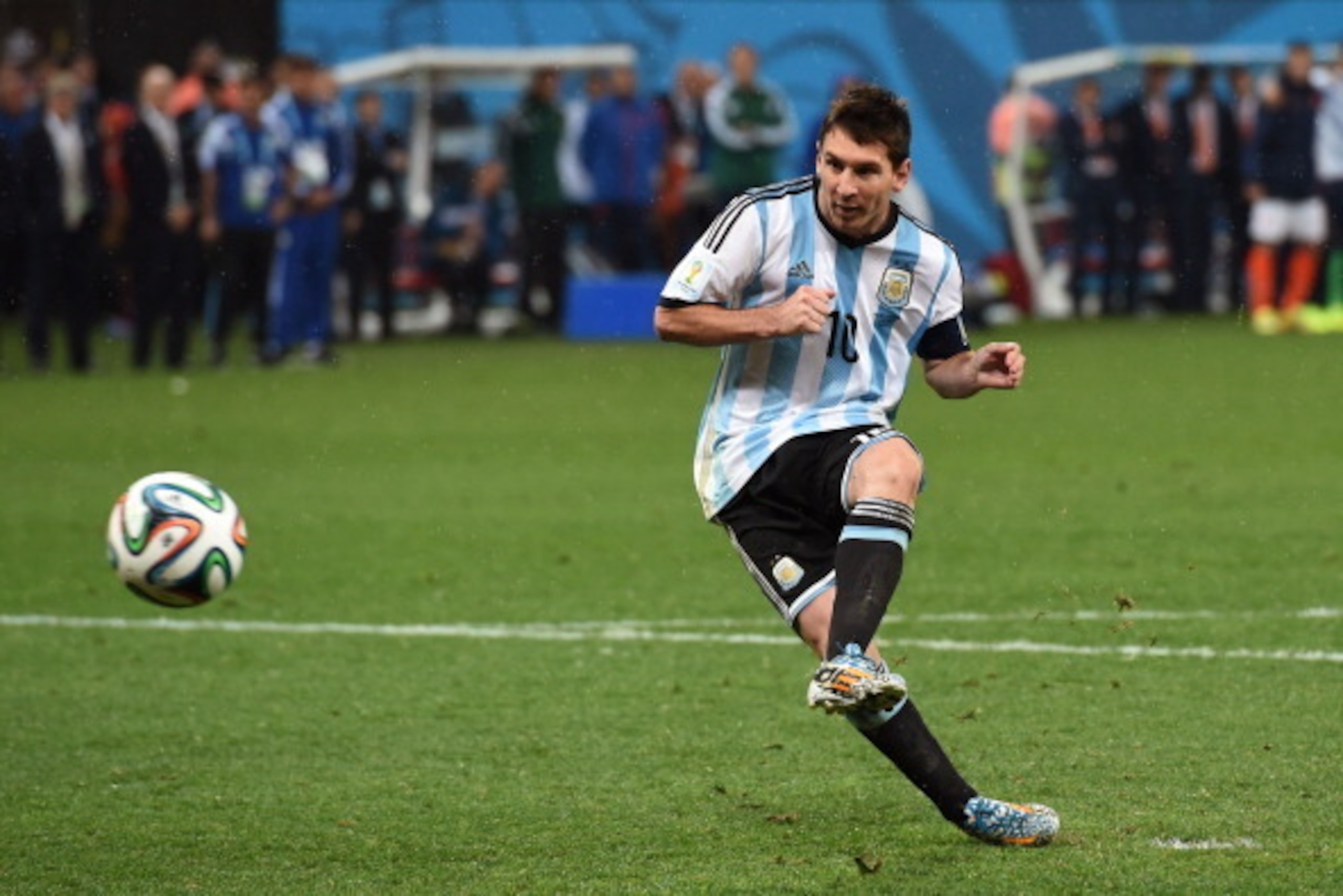SAO PAULO, BRAZIL - JULY 09: Lionel Messi of Argentina shoots and scores his penalty kick in a shootout during the 2014 FIFA World Cup Brazil Semi Final match between the Netherlands and Argentina at Arena de Sao Paulo on July 9, 2014 in Sao Paulo, Brazil